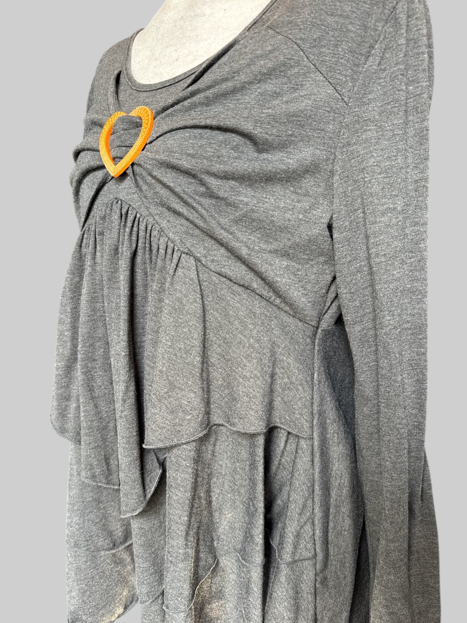 0X Grey long sleeve shirt with lots of ruffles and pleated layers, and brown heart detail