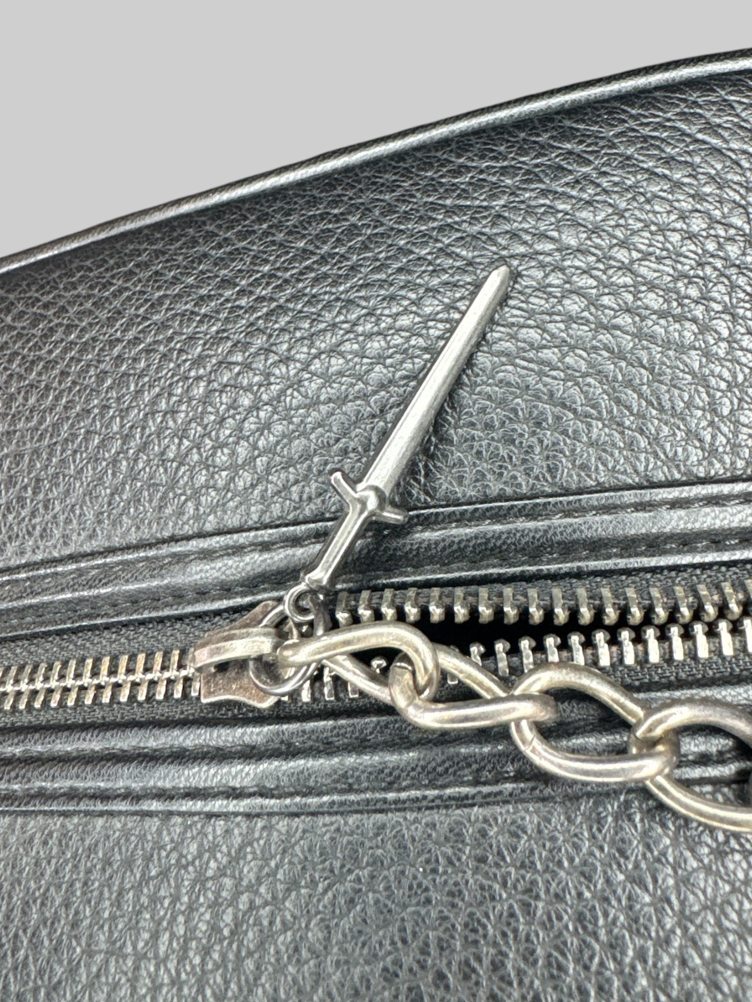 NWT black “The Witcher “bag with emblem on front, and decorative zipper chain