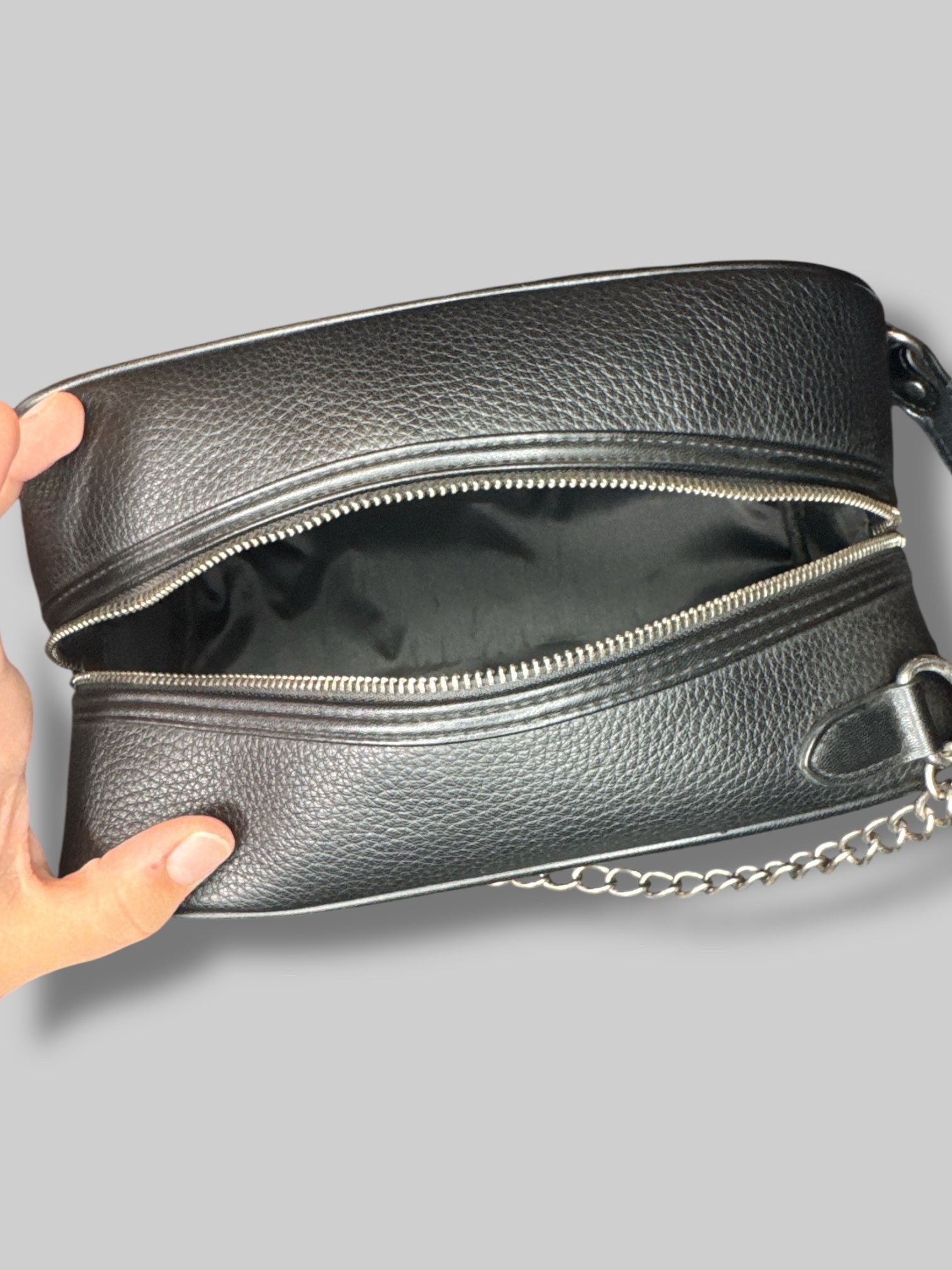 NWT black “The Witcher “bag with emblem on front, and decorative zipper chain