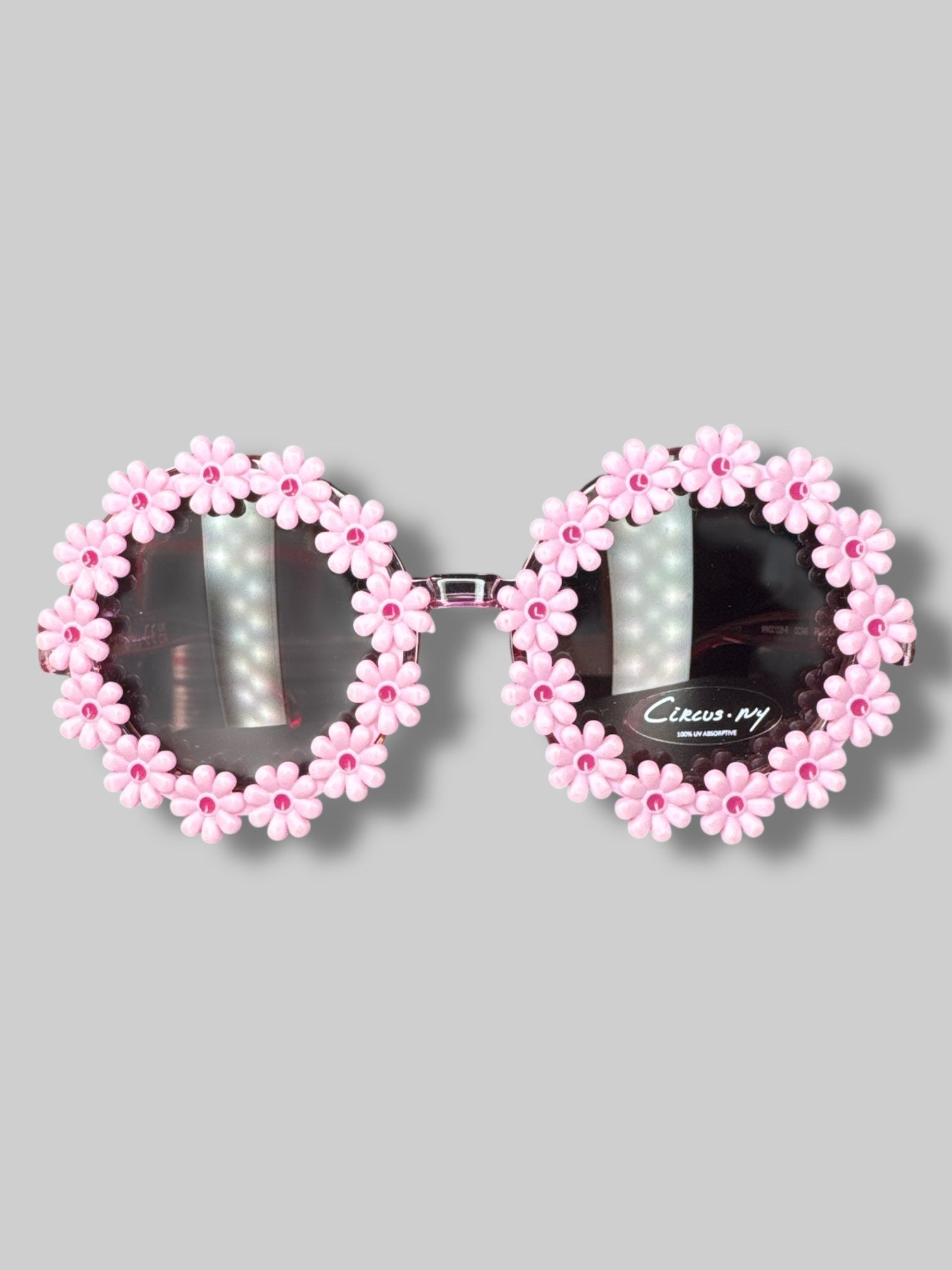 Pink round sunglasses with flower decoration on lenses