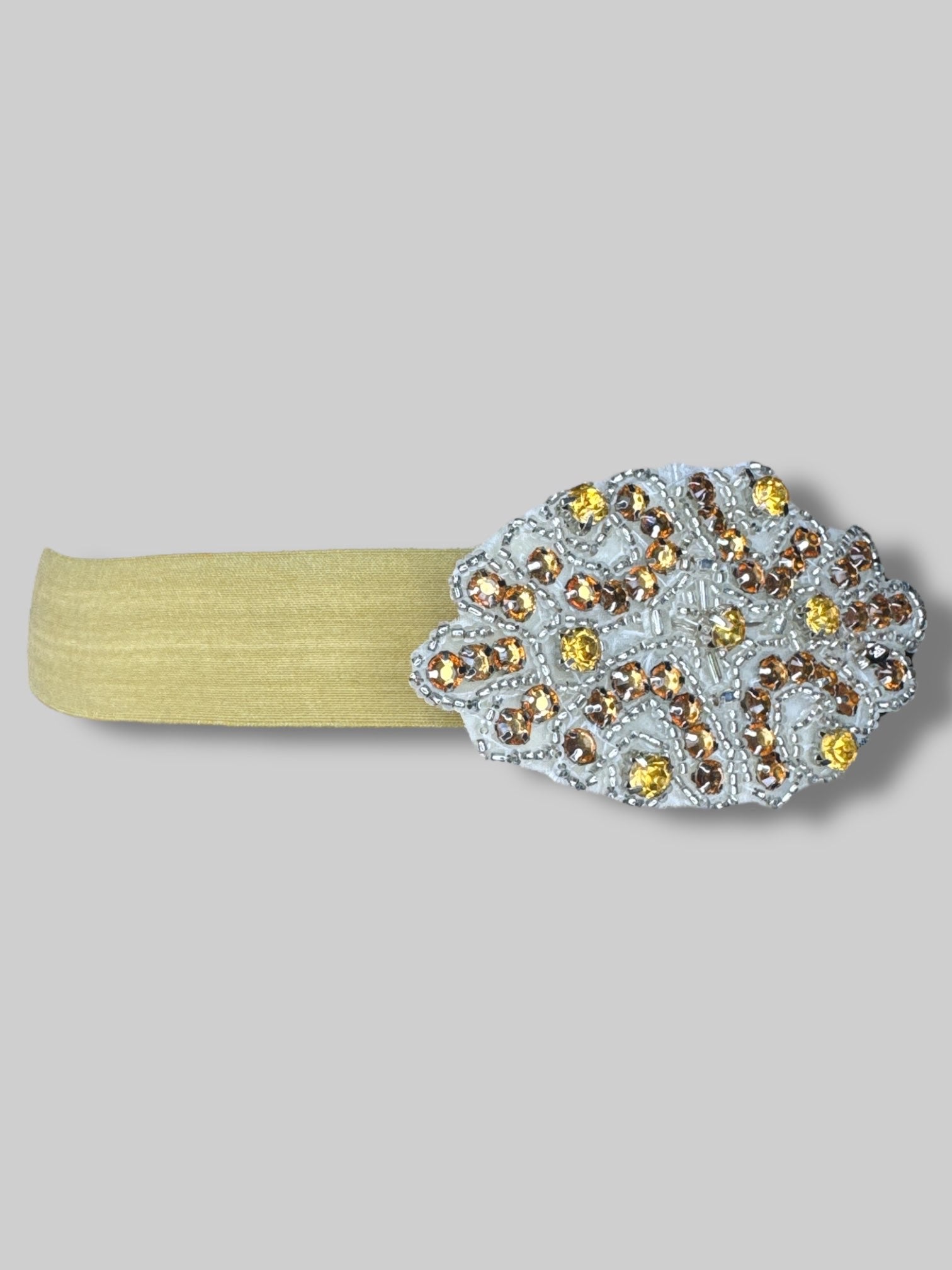 Gold stretchy headband with bedazzled pendant