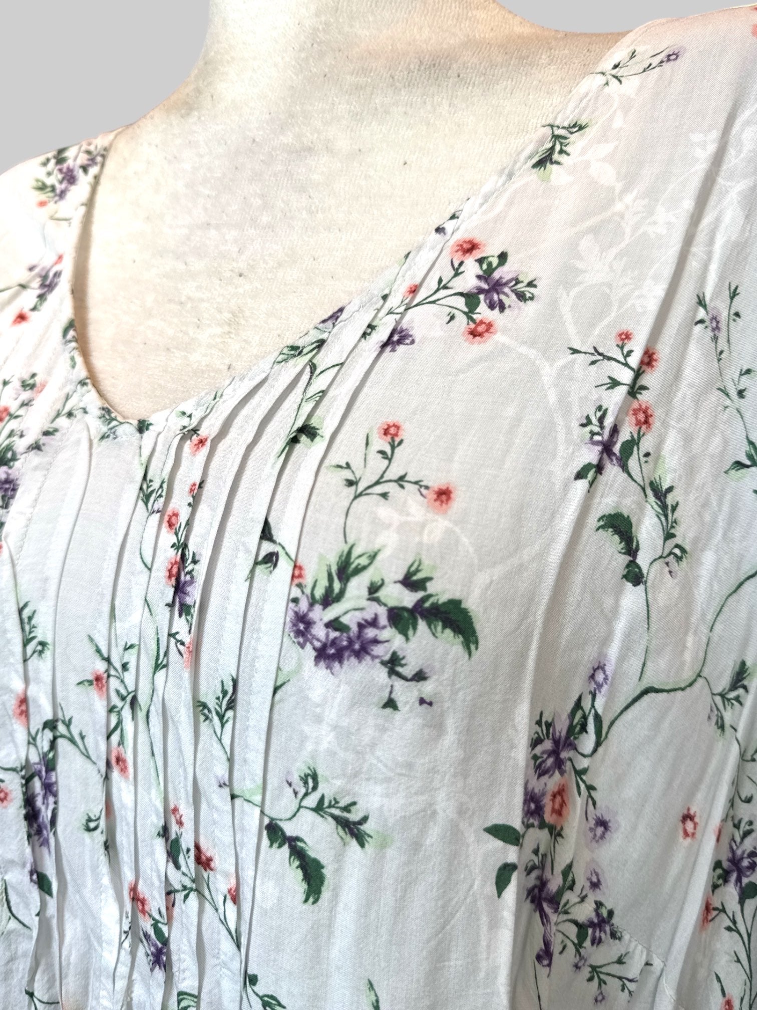 3X White flowy shirt with pleating, buttons on the arms, and purple pink green and white florals