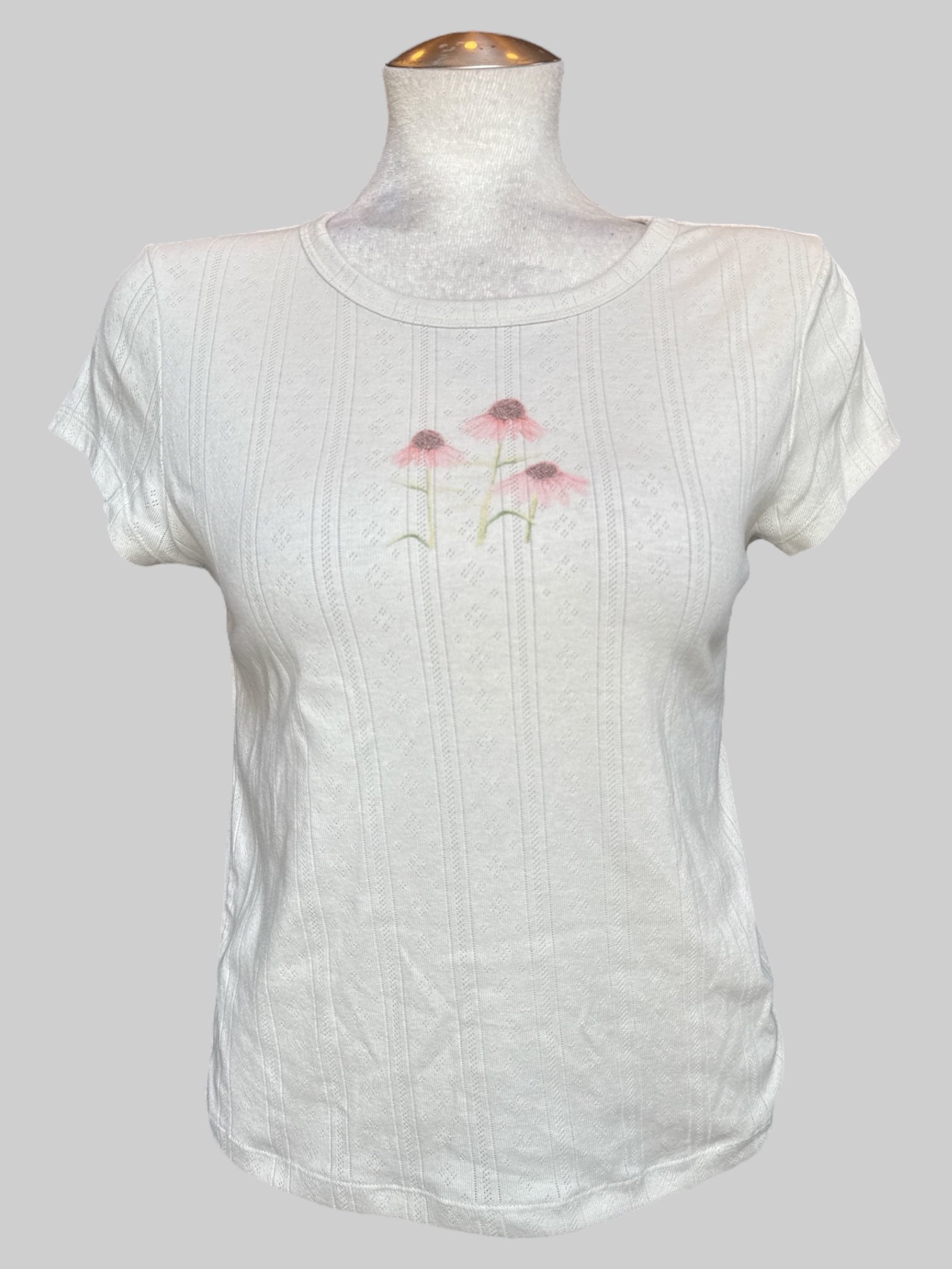 L White knit t shirt with pink and green floral graphic