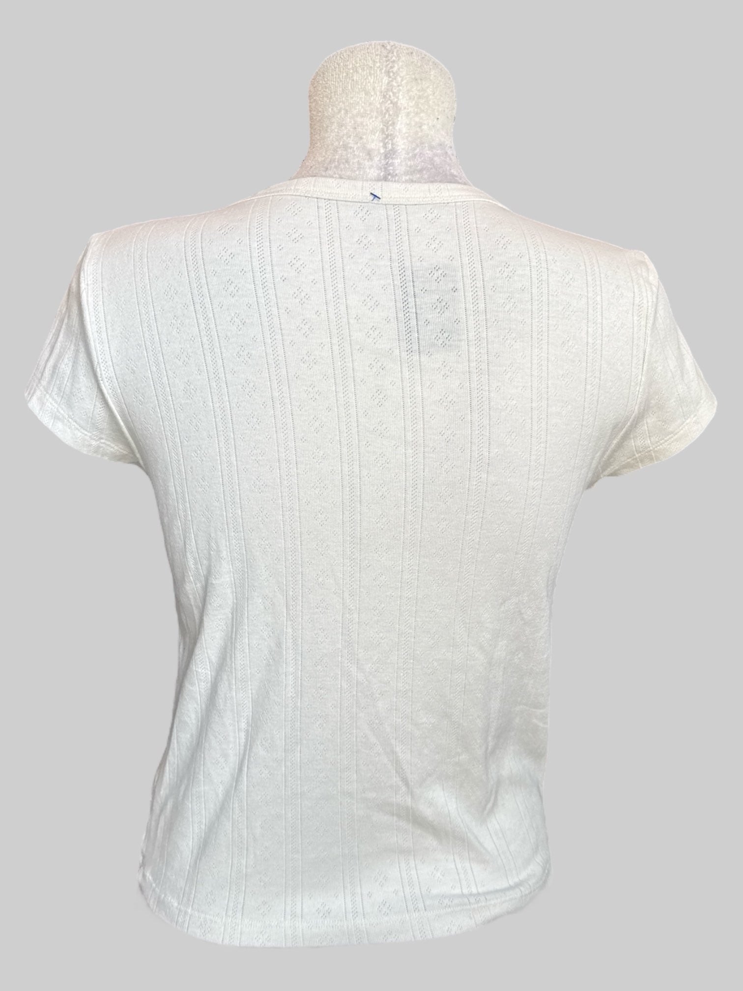 L White knit t shirt with pink and green floral graphic