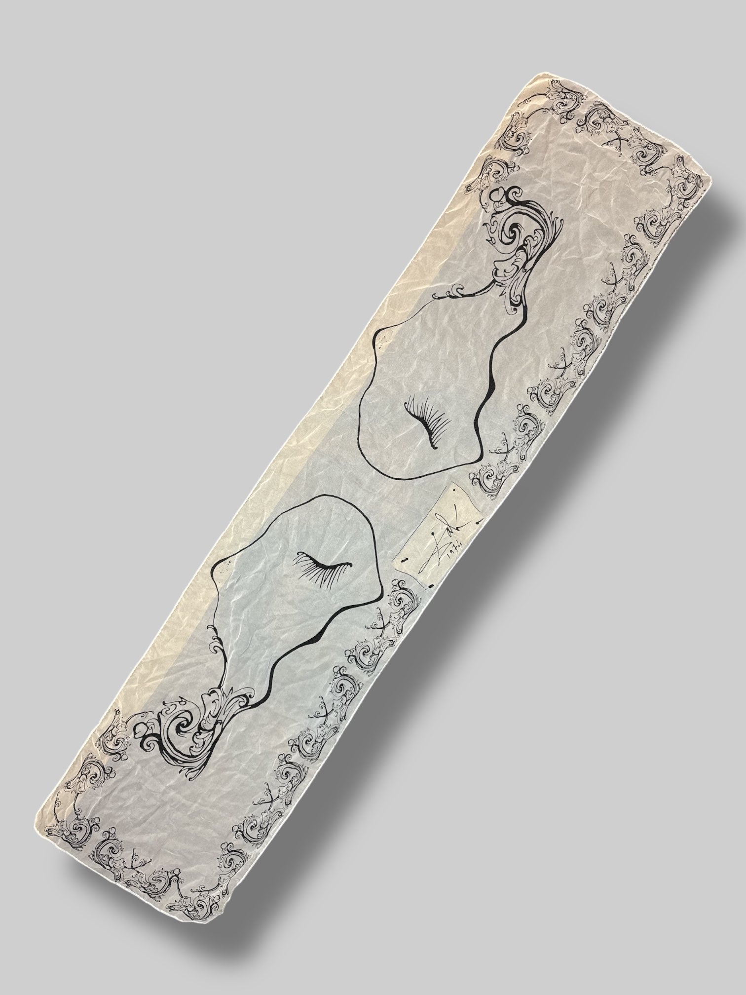 Rare 100% silk scarf from Salvador Dali museum with black ornate design, and eyelashes