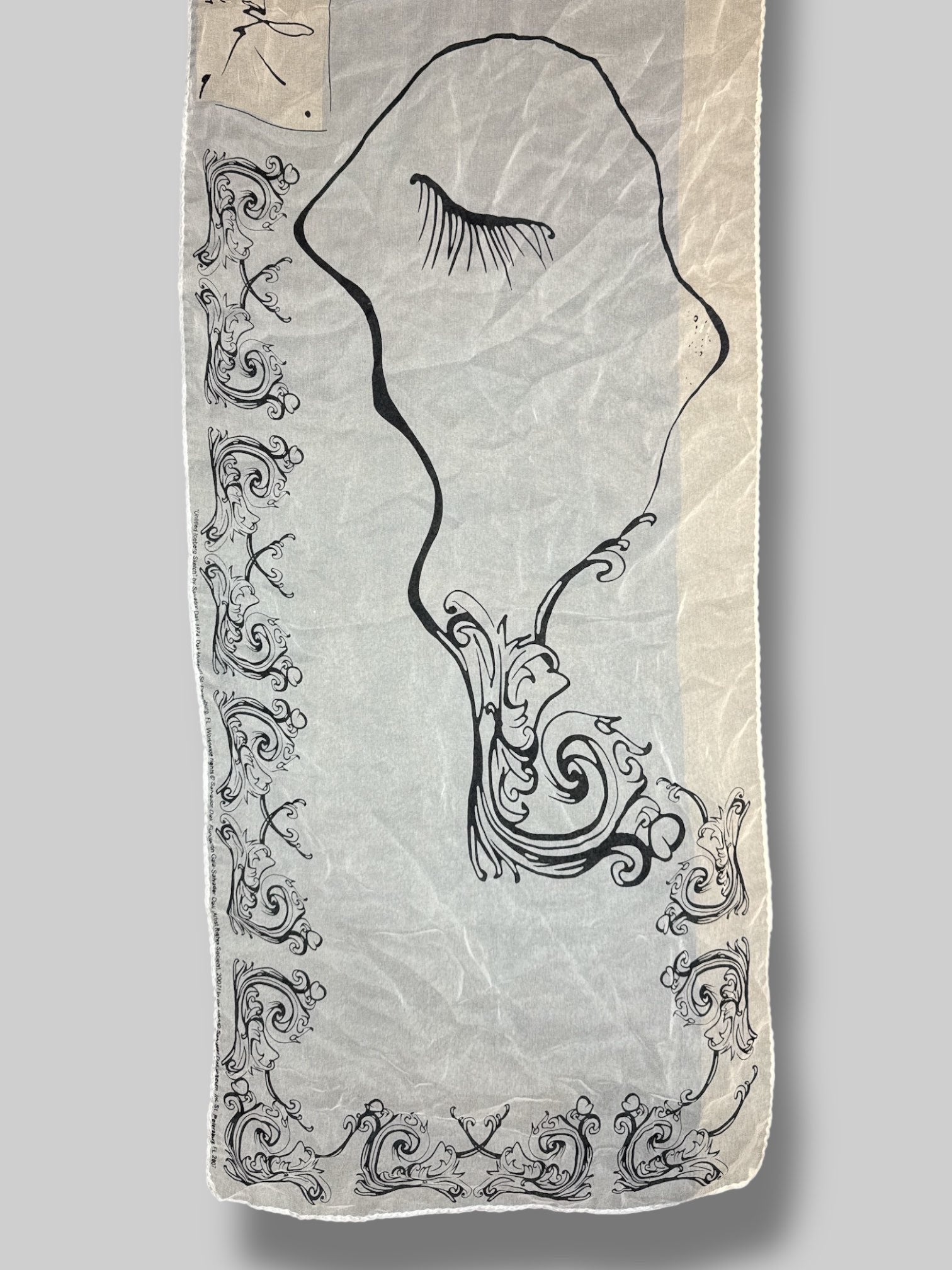 Rare 100% silk scarf from Salvador Dali museum with black ornate design, and eyelashes