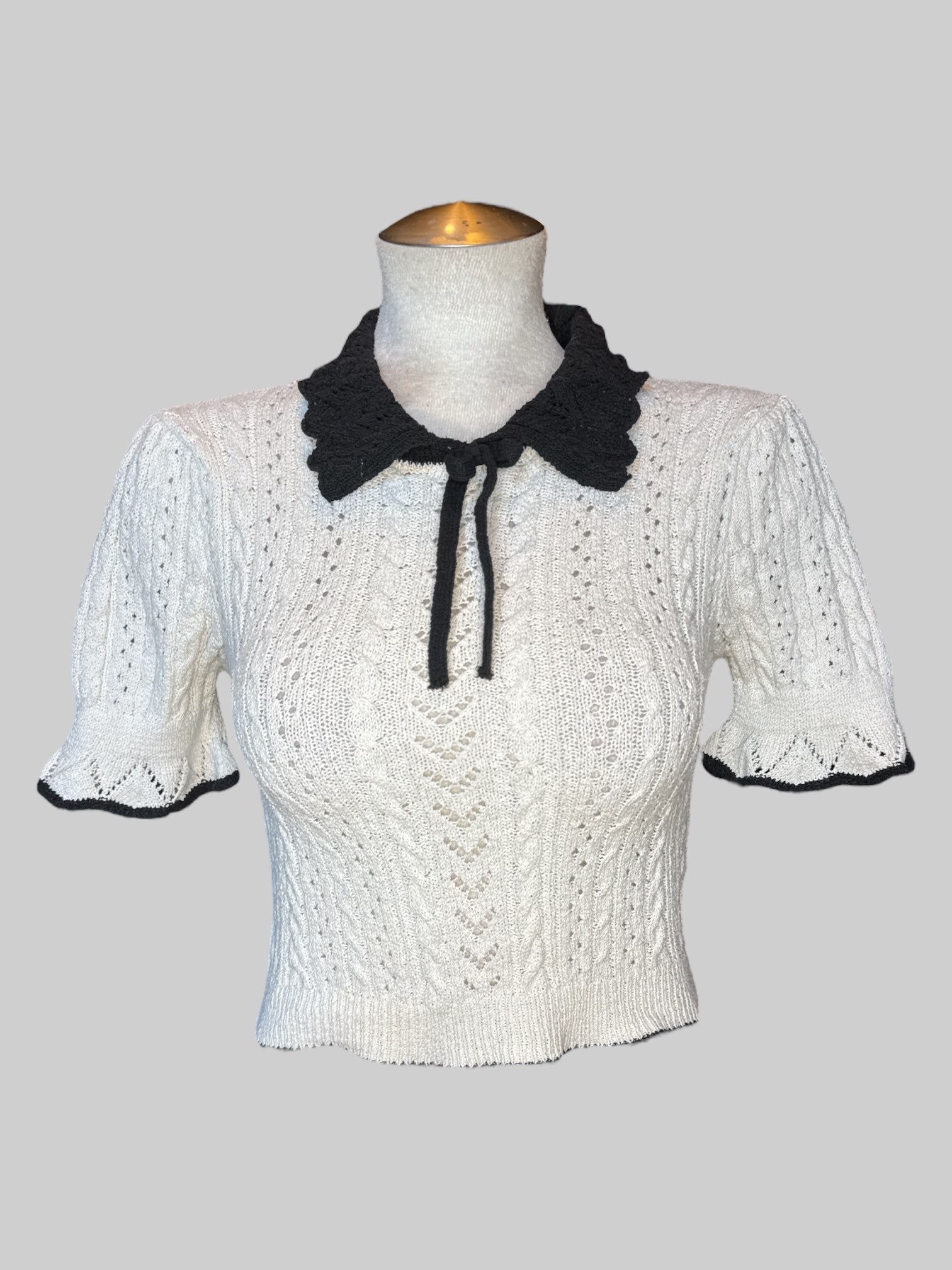S White knit top with black collar and tie
