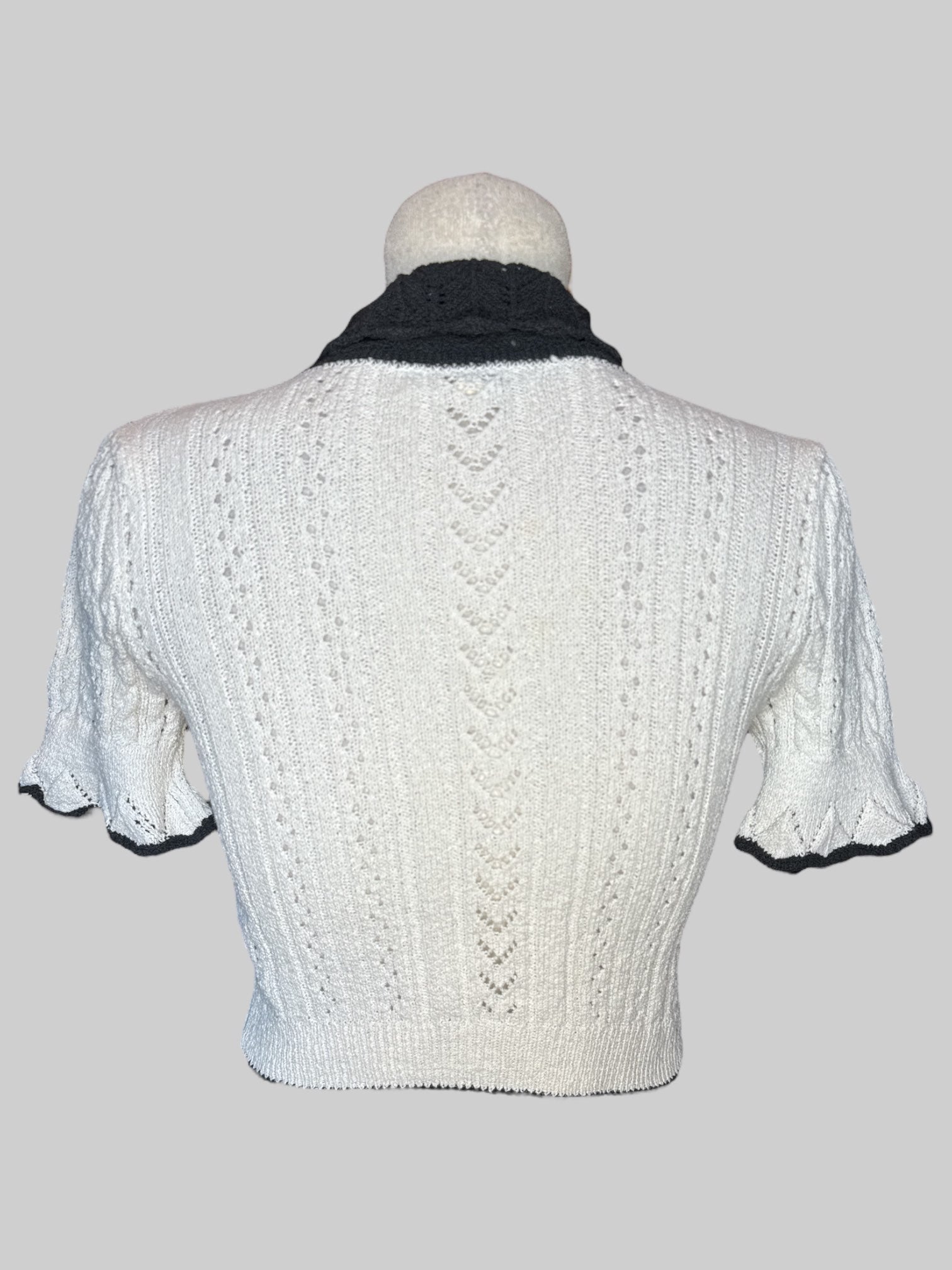 S White knit top with black collar and tie
