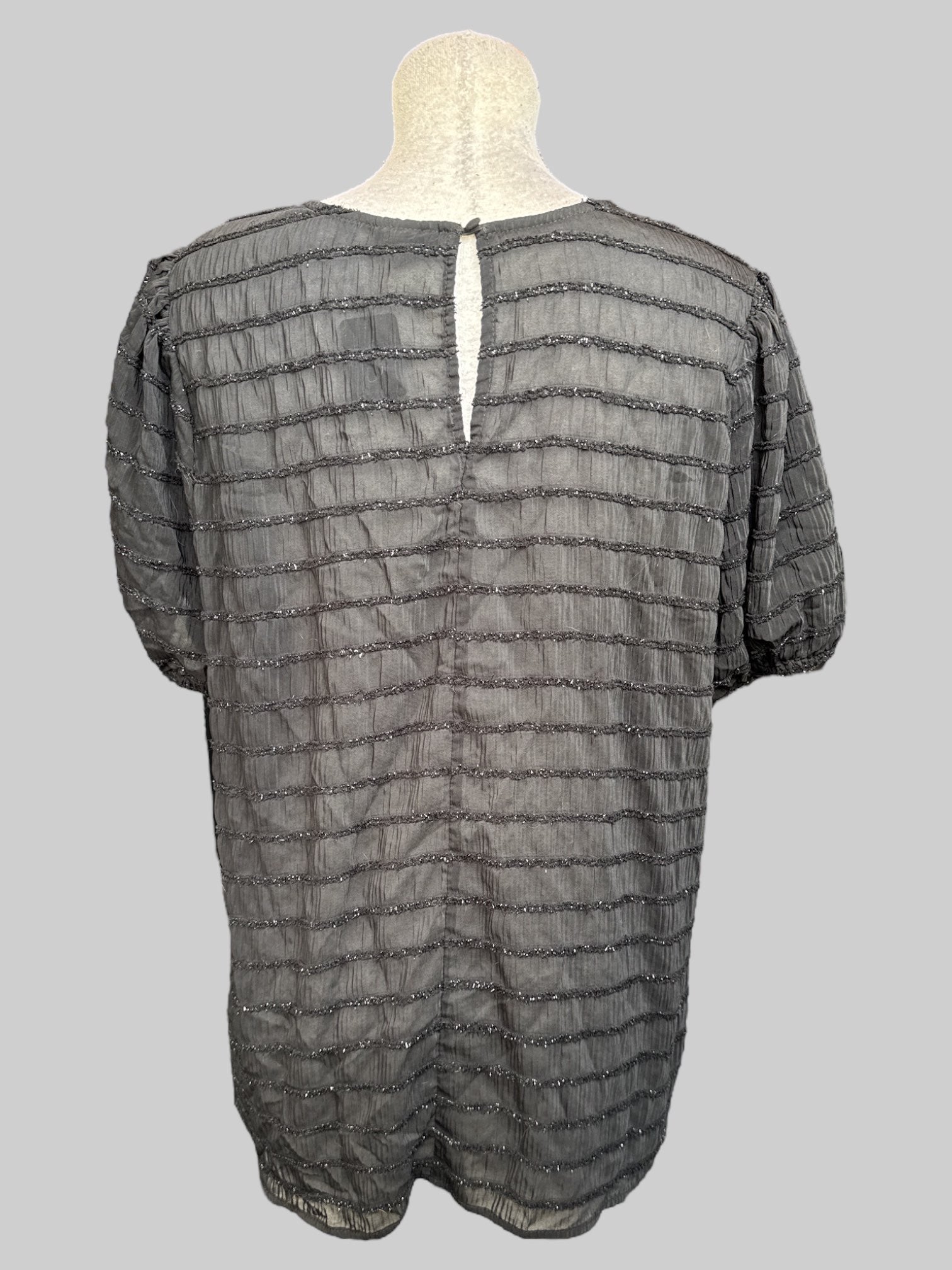 1X Sheer black top with balloon sleeves, keyhole back, and textured metallic stripes
