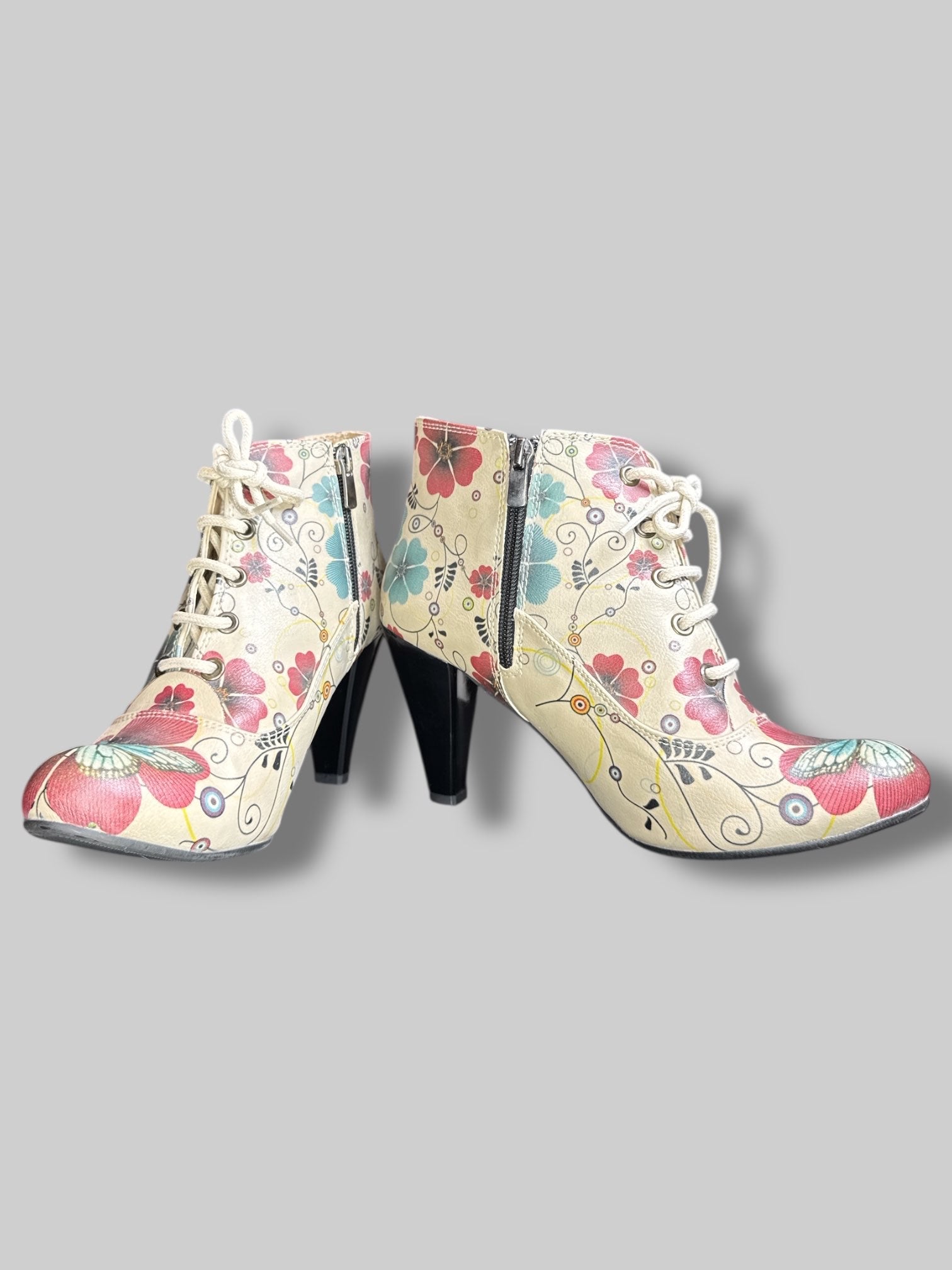 Beige boot heels with lacing, red and blue florals, and zippers on sides