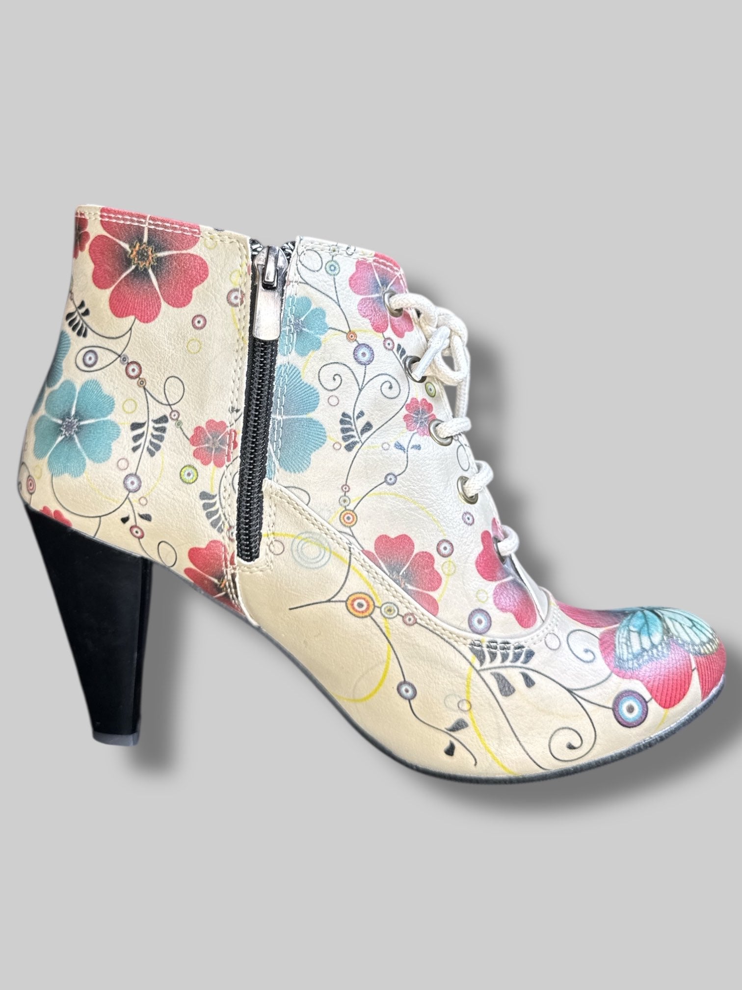 Beige boot heels with lacing, red and blue florals, and zippers on sides