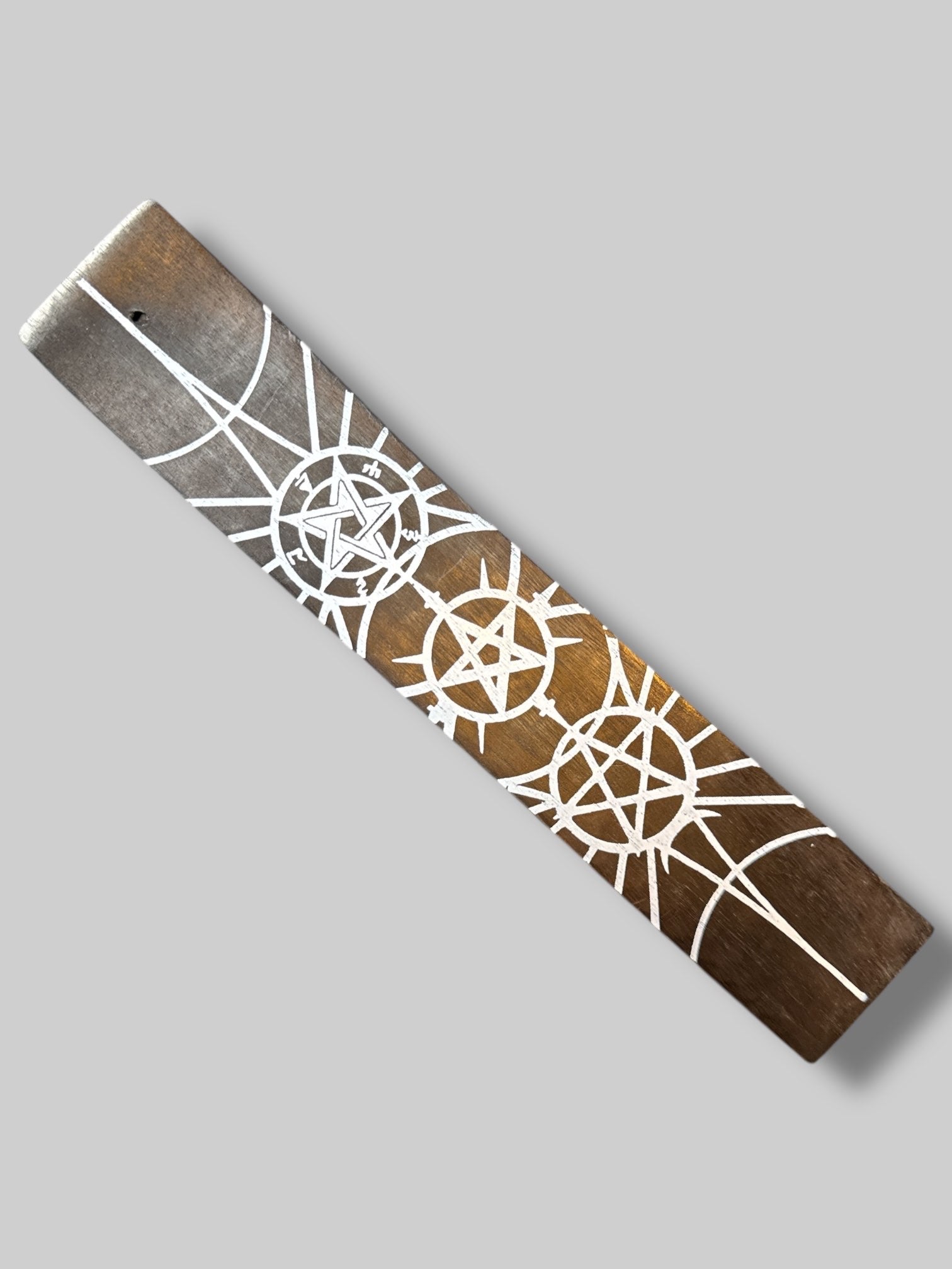Black incense holder with white pentagram designs