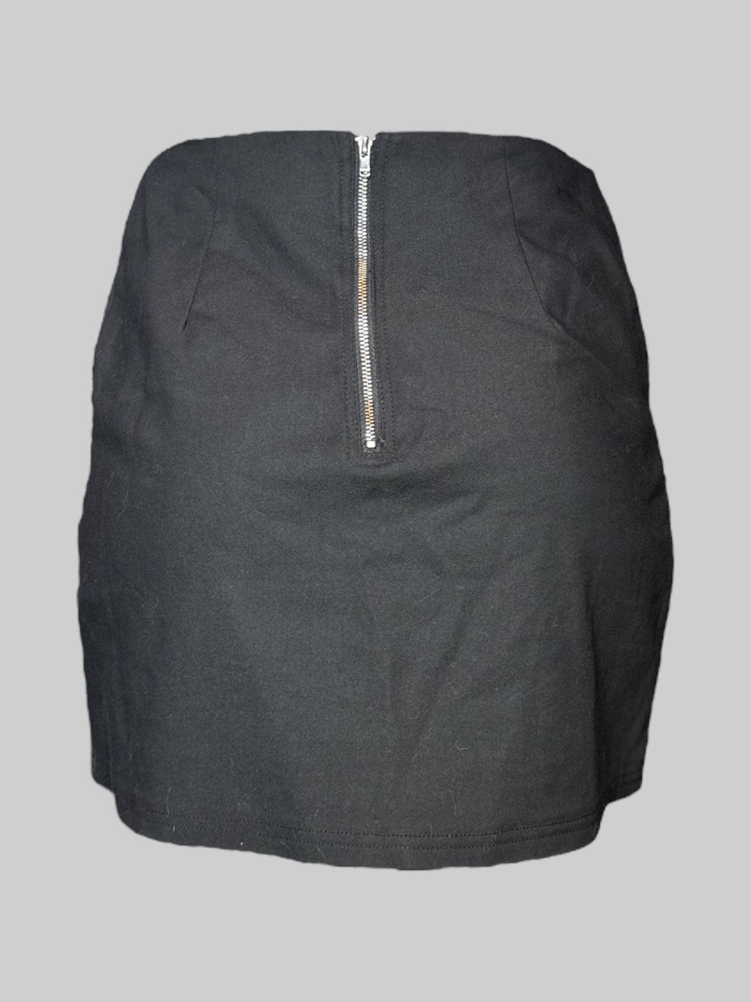 M black mini skirt with faux claps on front pockets, and zipper on back