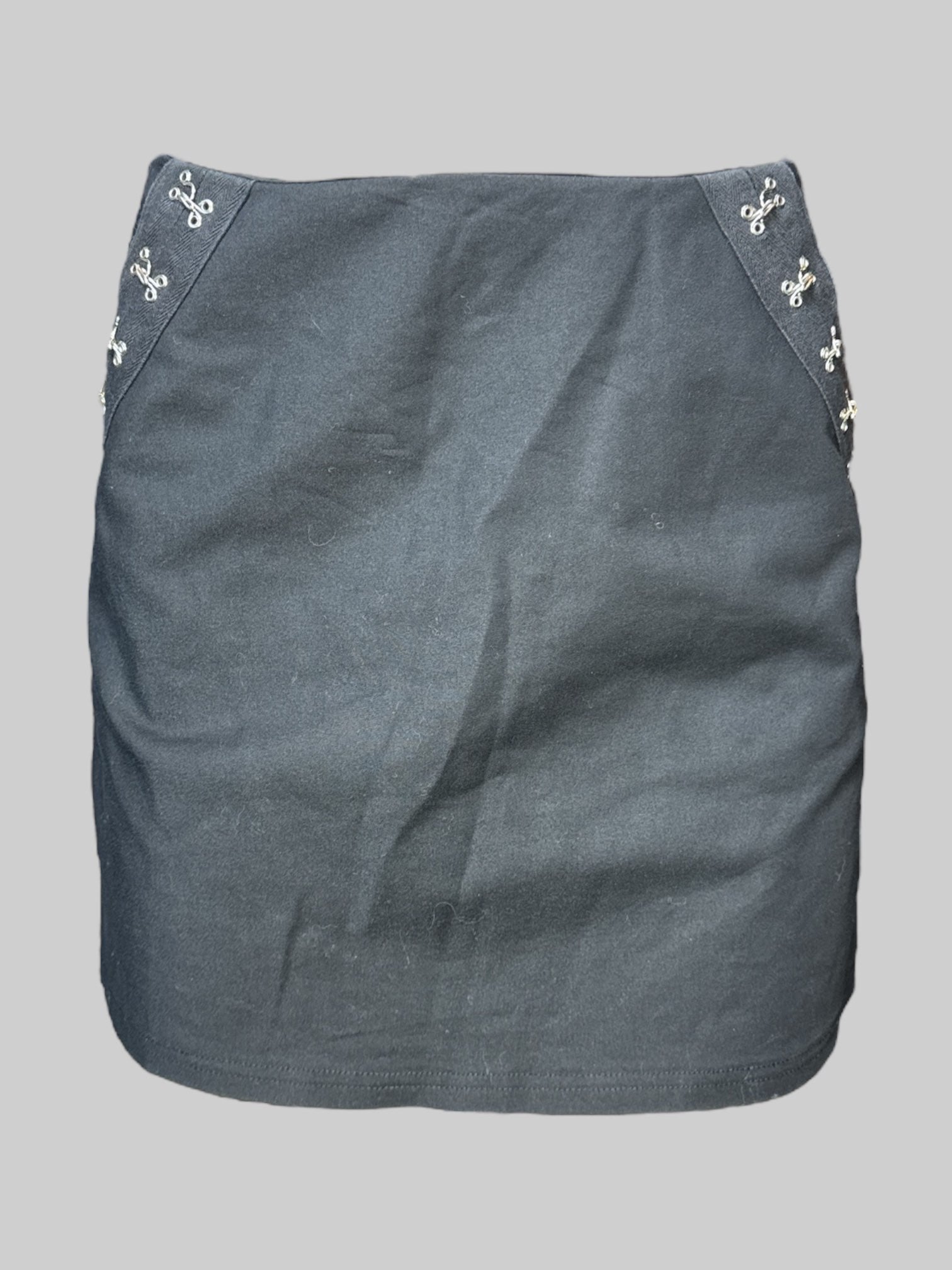 M black mini skirt with faux claps on front pockets, and zipper on back