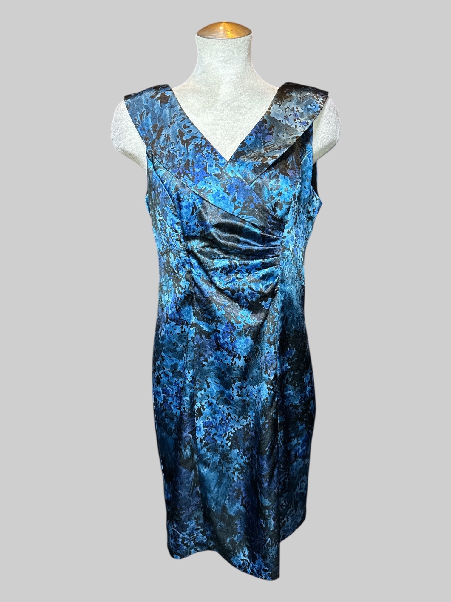 L blue, purple and black, botanical print sleeveless dress with pleated ruffle design on front and neck line, and zipper on back