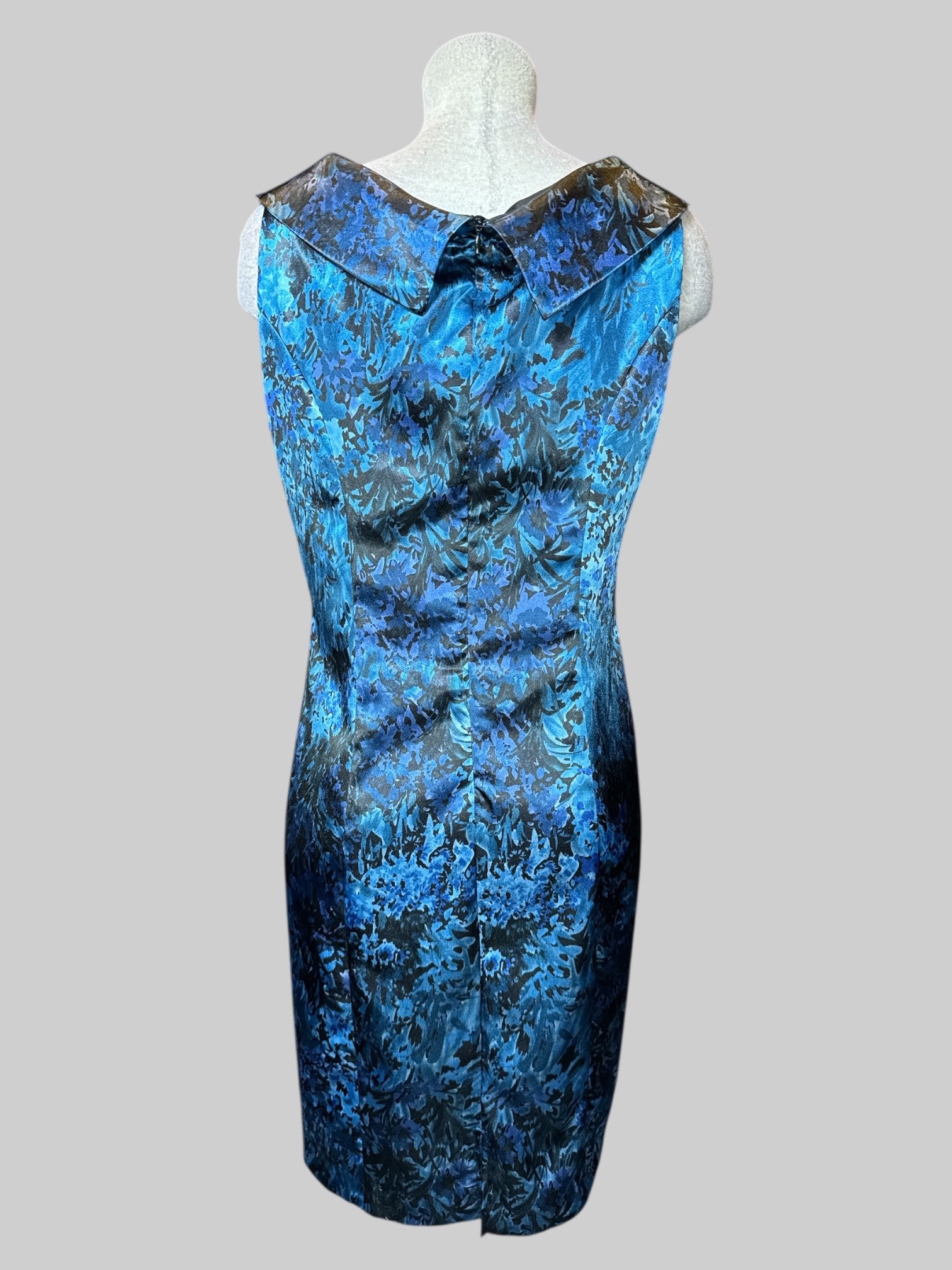 L blue, purple and black, botanical print sleeveless dress with pleated ruffle design on front and neck line, and zipper on back