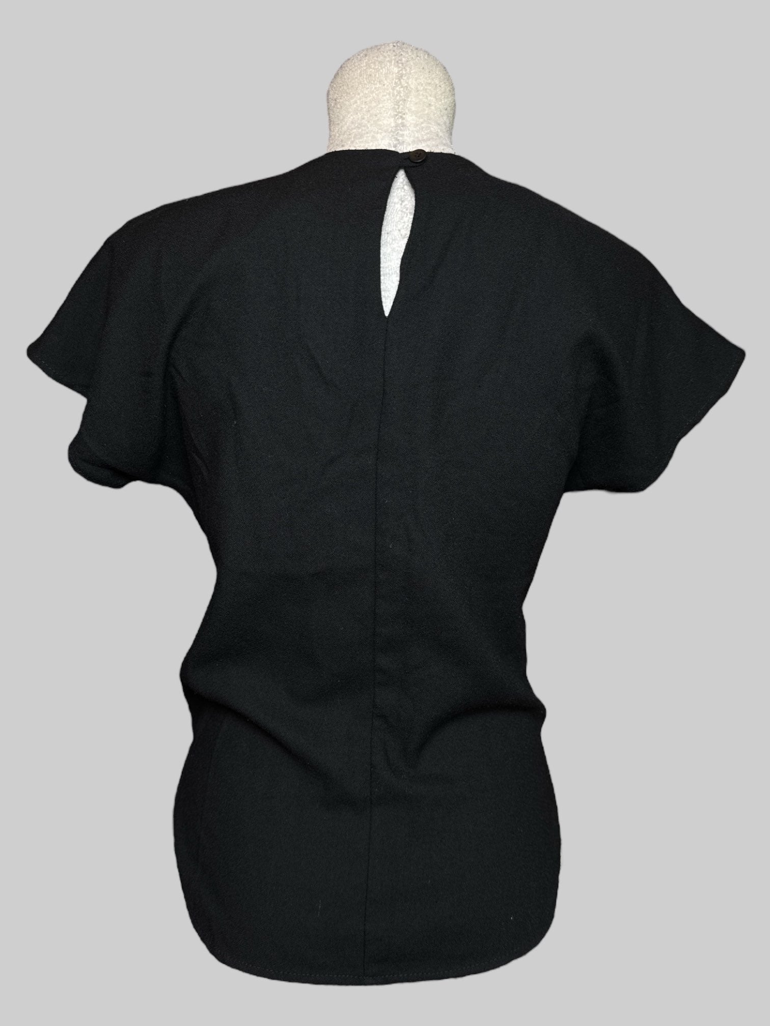 S vintage black short sleeve blouse with white embroidery, faux pearls, keyhole back, and slits on the side