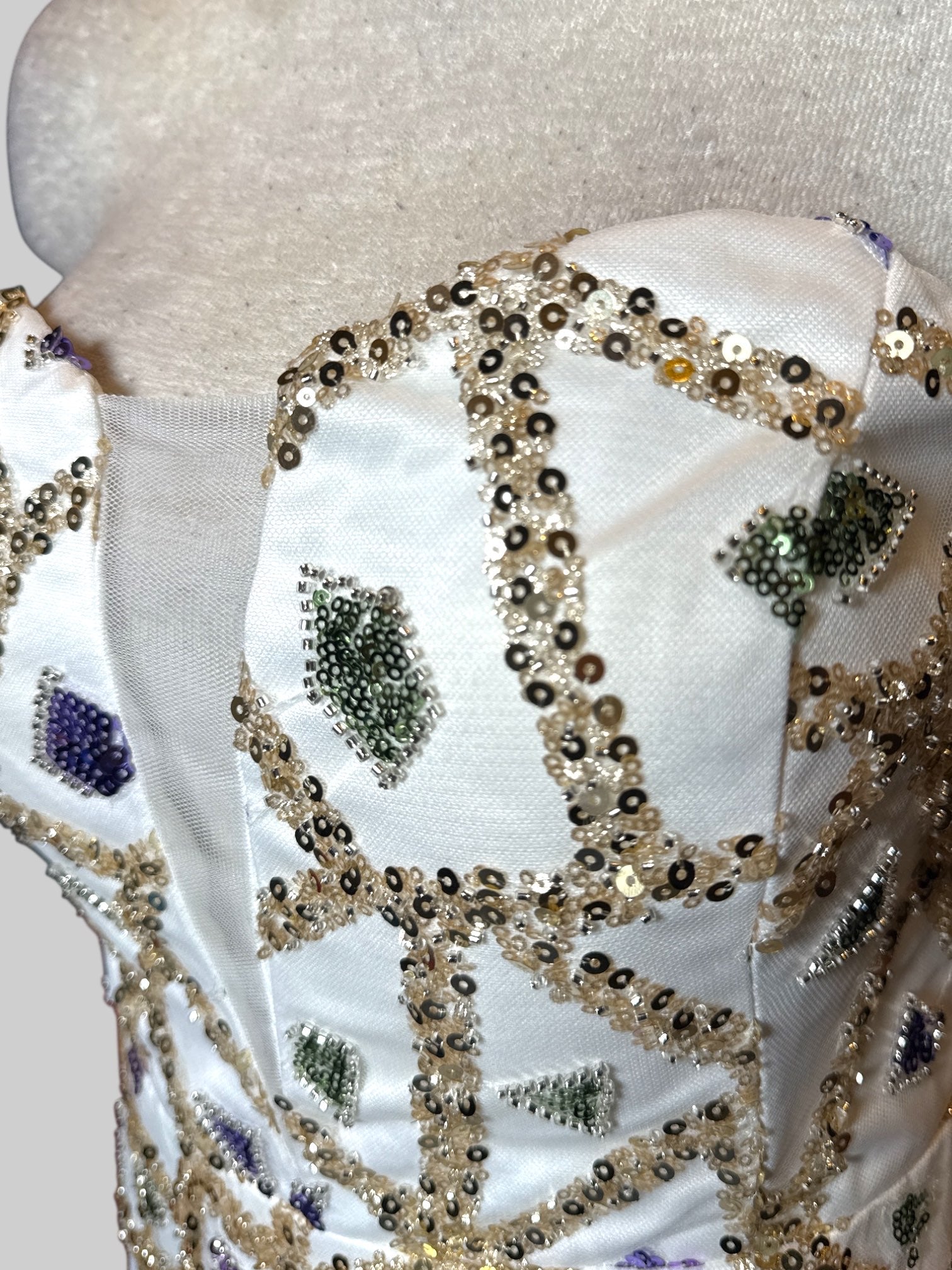 M white formal maxi mermaid style dress with green, purple, and light pink geometric sequin pattern and lots of tule