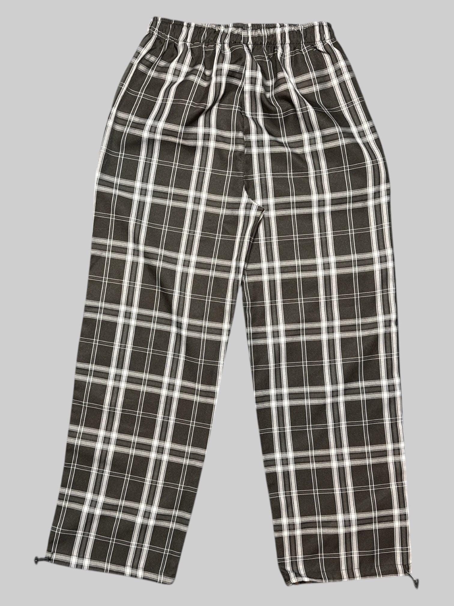 L black, white, and gray plaid pants with elastic waistband and drawstring bottoms