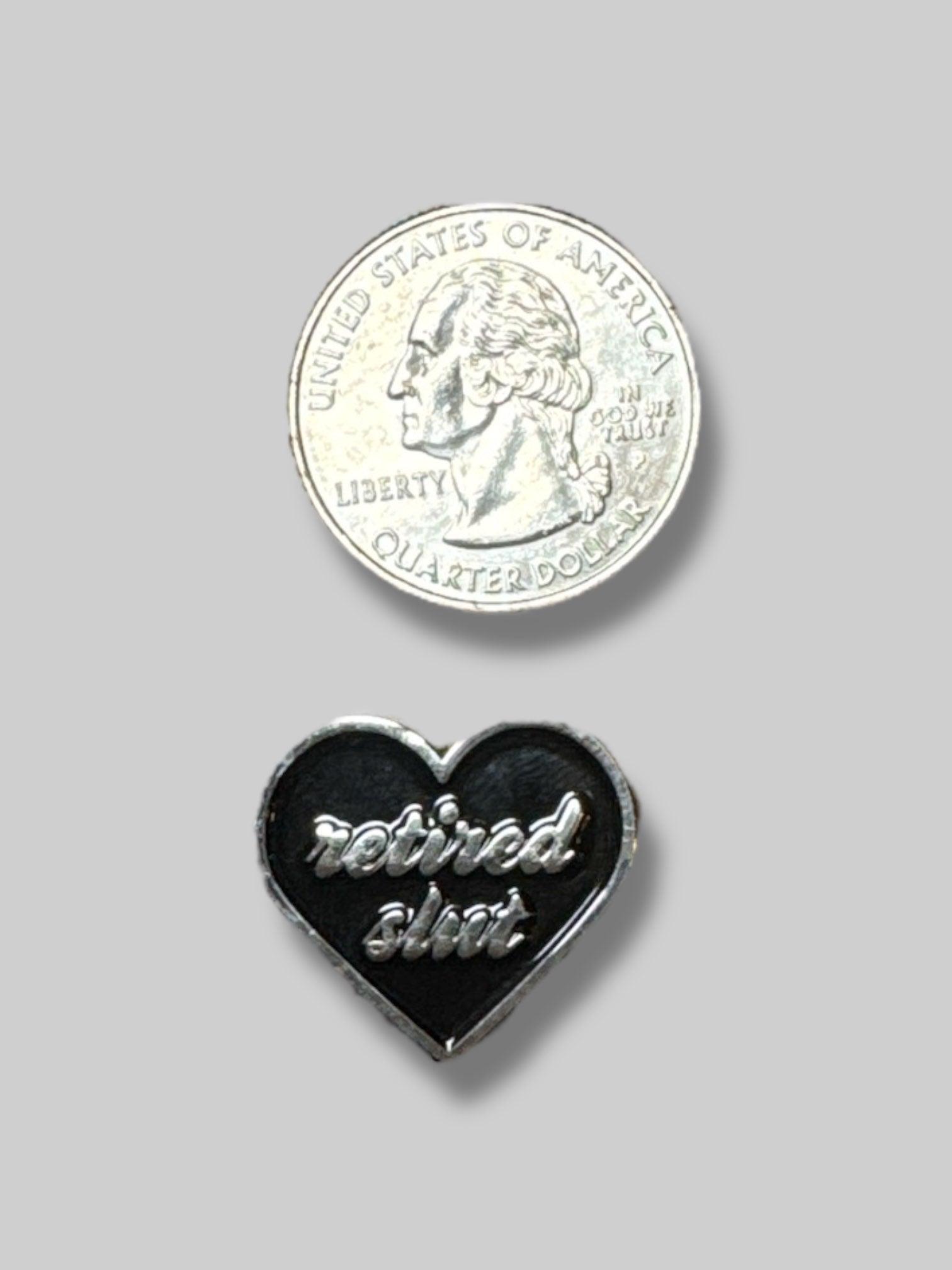 “Retired Slut” black enamel heart shaped pin