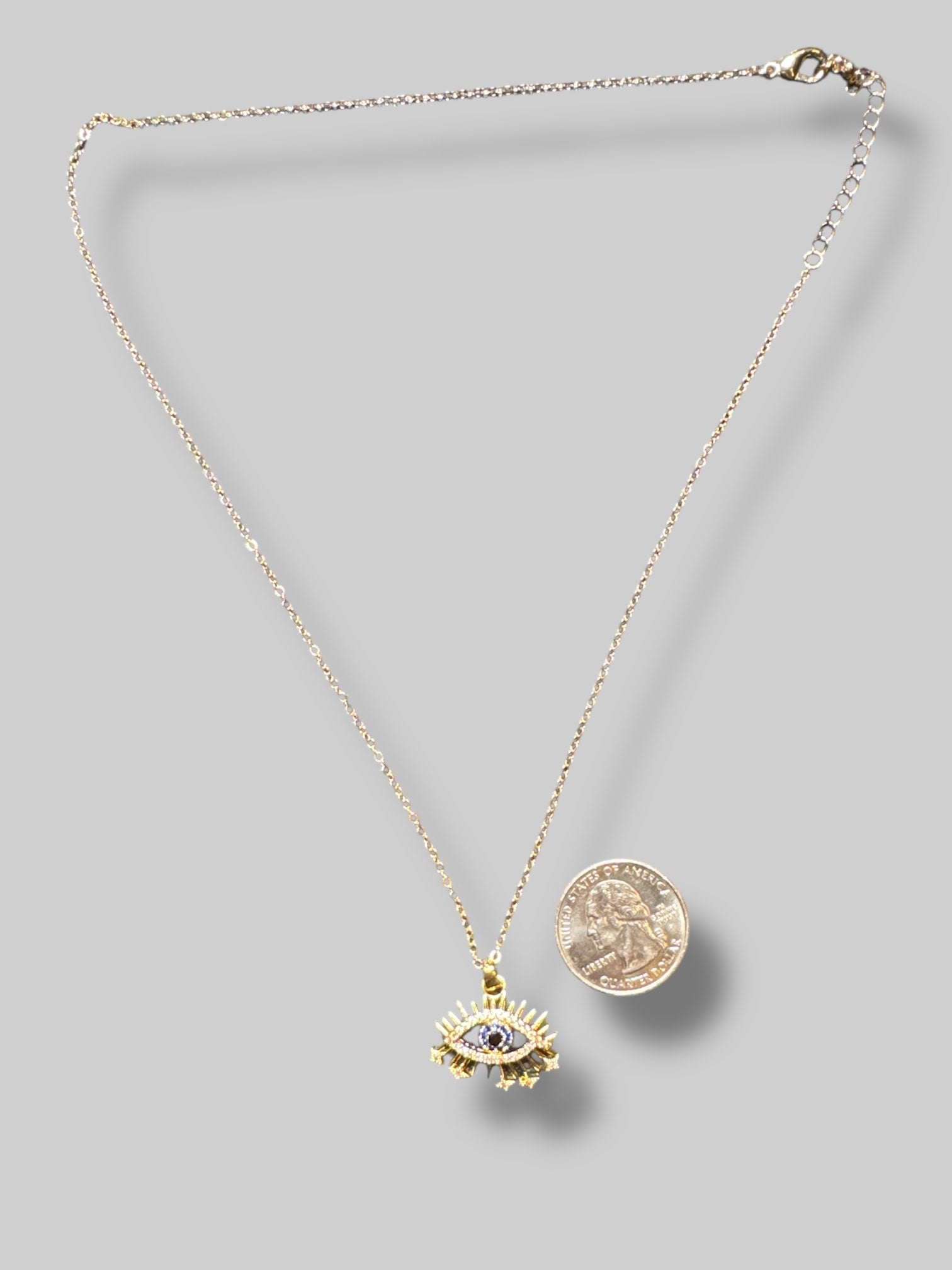 Gold tone evil eye necklace with rhinestones