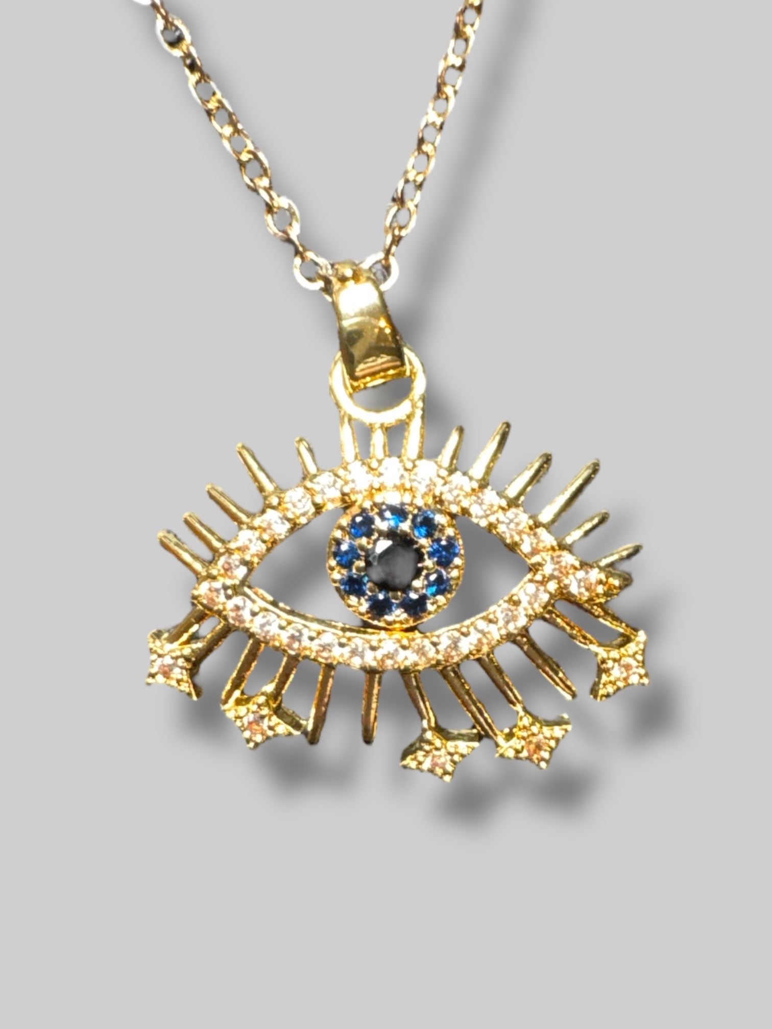 Gold tone evil eye necklace with rhinestones