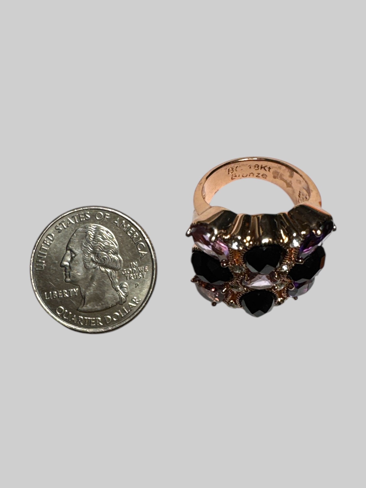 14k bronze size 7 sing with purple, black, and white rhinestone ring