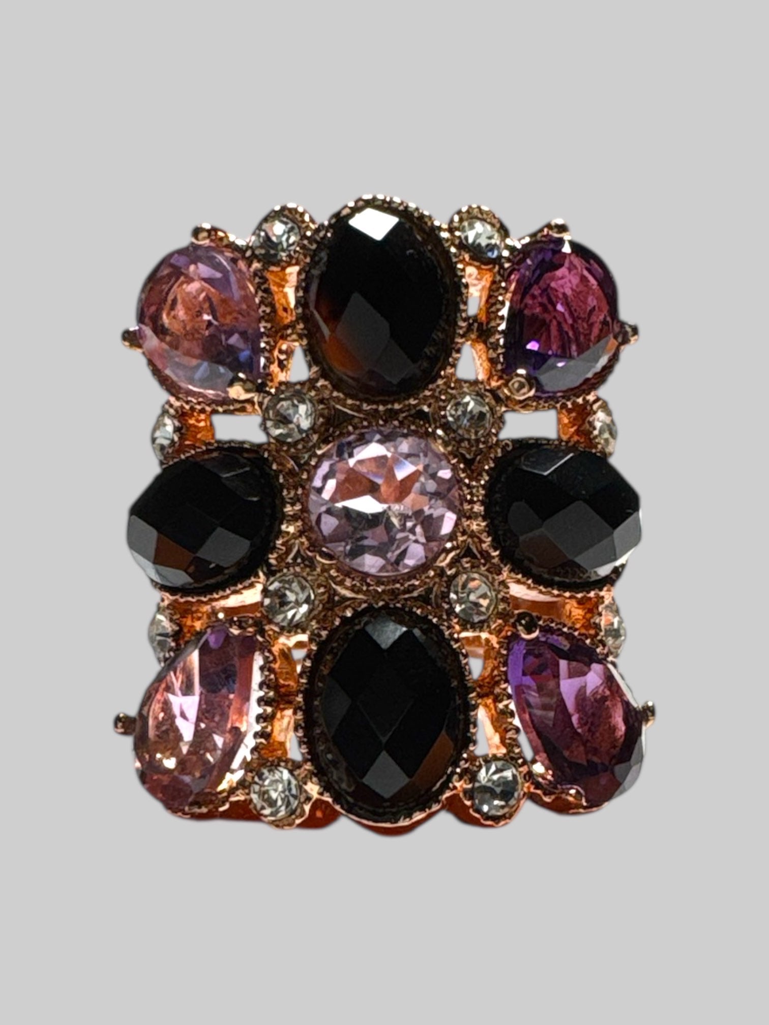 14k bronze size 7 sing with purple, black, and white rhinestone ring
