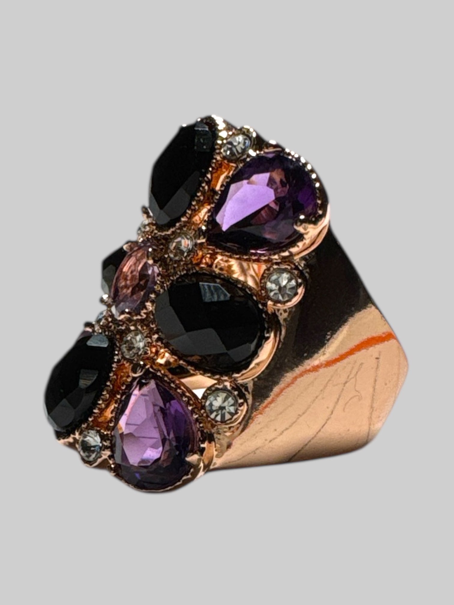 14k bronze size 7 sing with purple, black, and white rhinestone ring