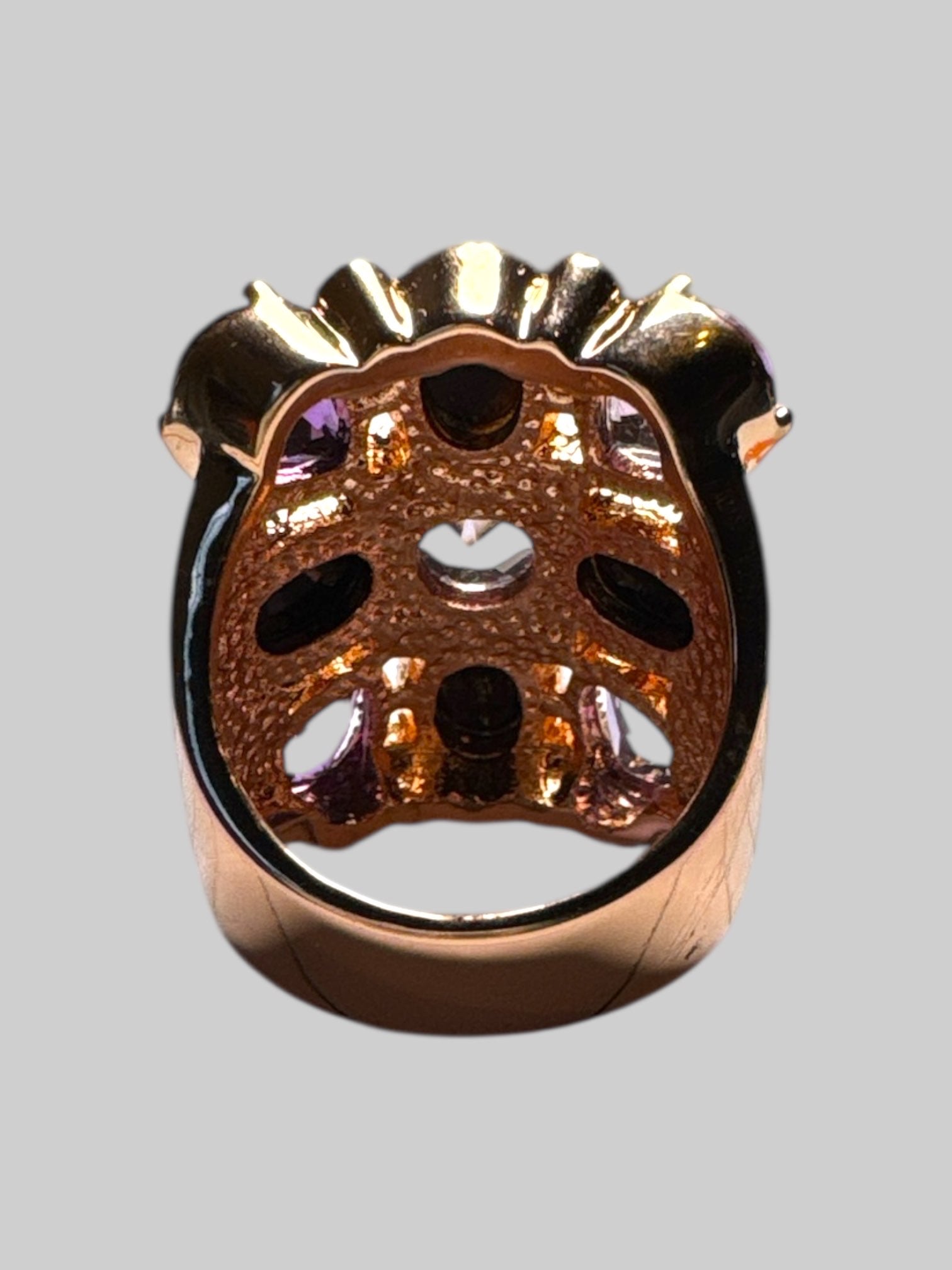 14k bronze size 7 sing with purple, black, and white rhinestone ring