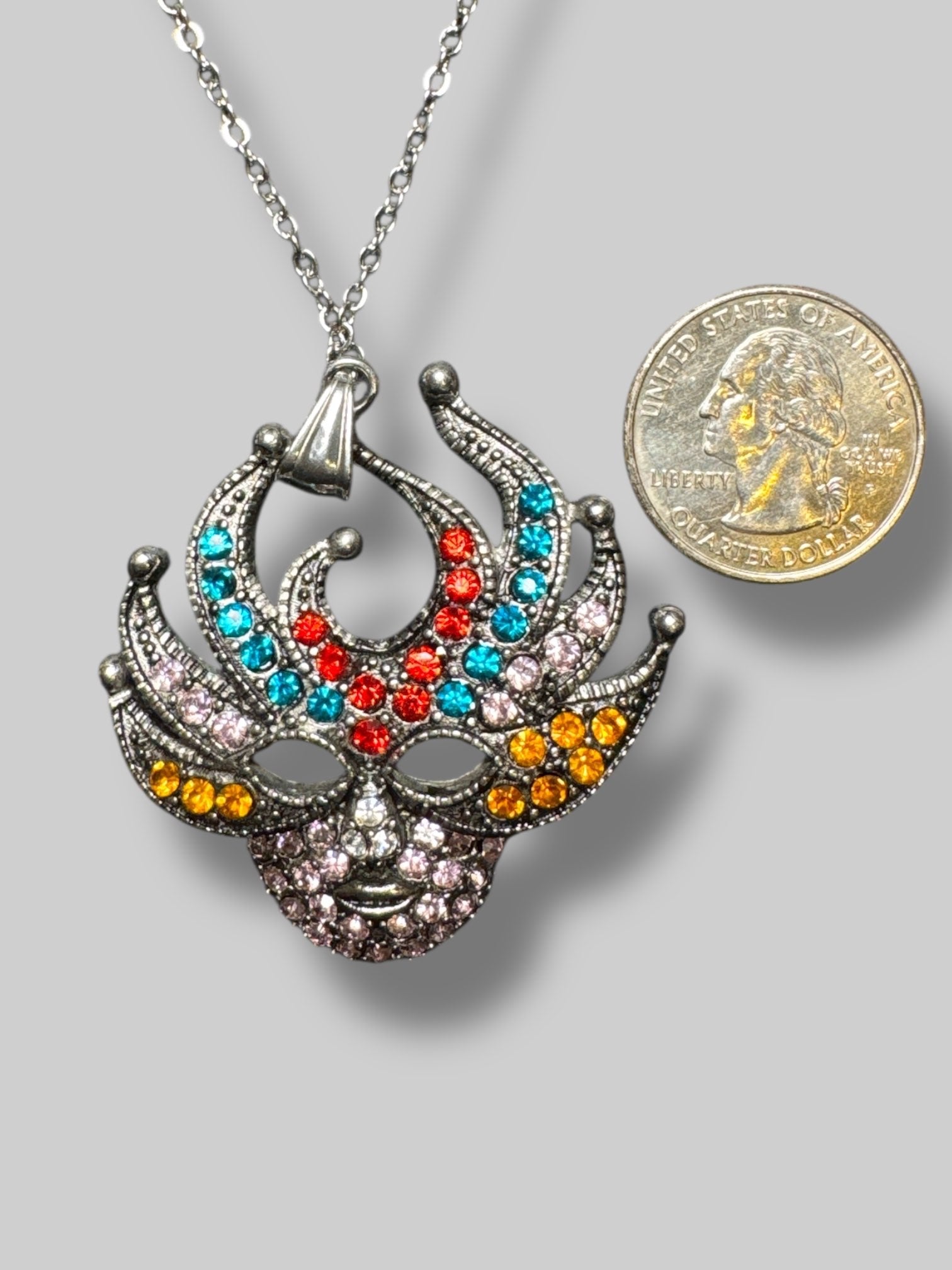 Silver tone multicolor rhinestone mask pendant with 15.5” chain