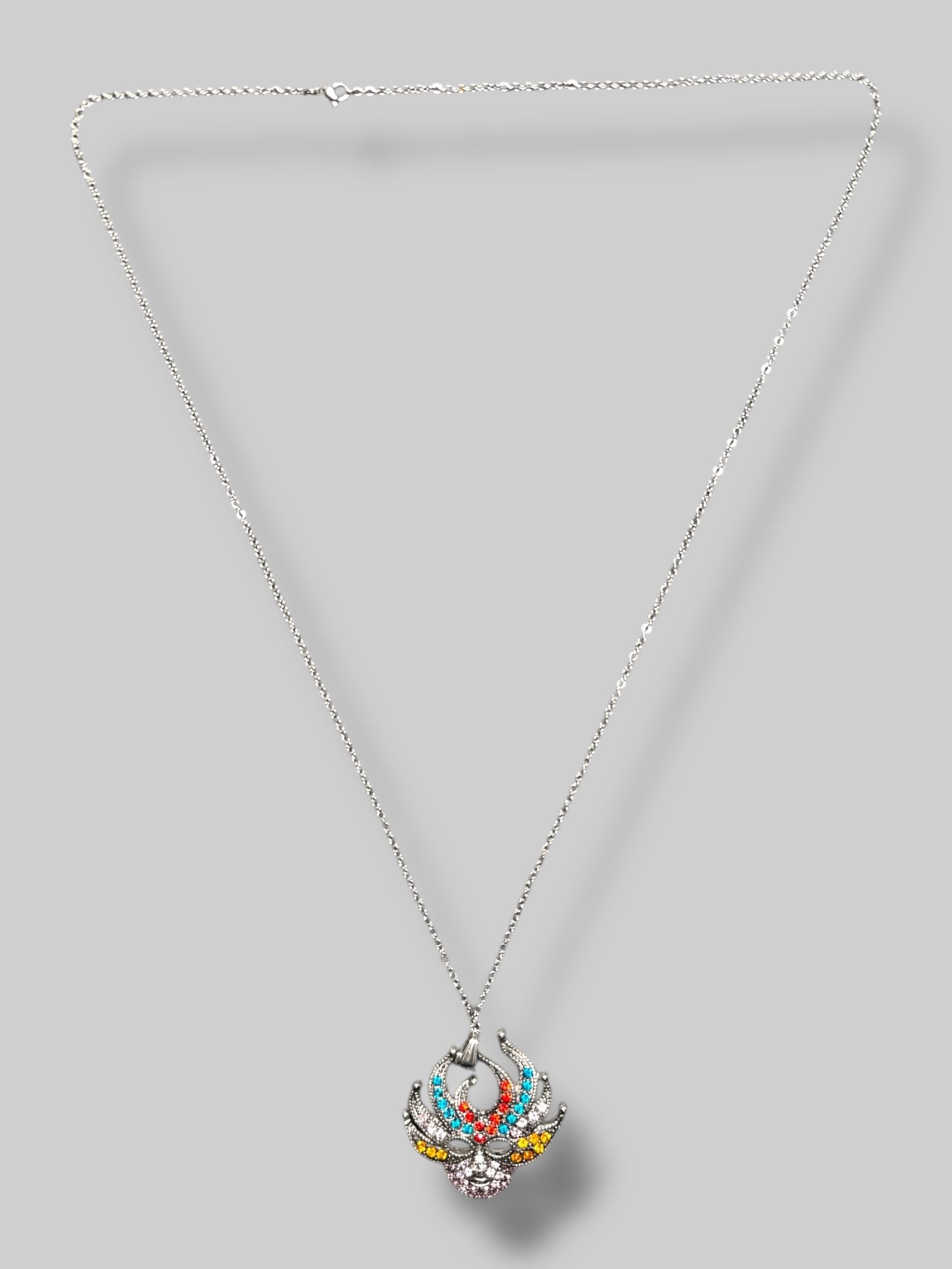 Silver tone multicolor rhinestone mask pendant with 15.5” chain