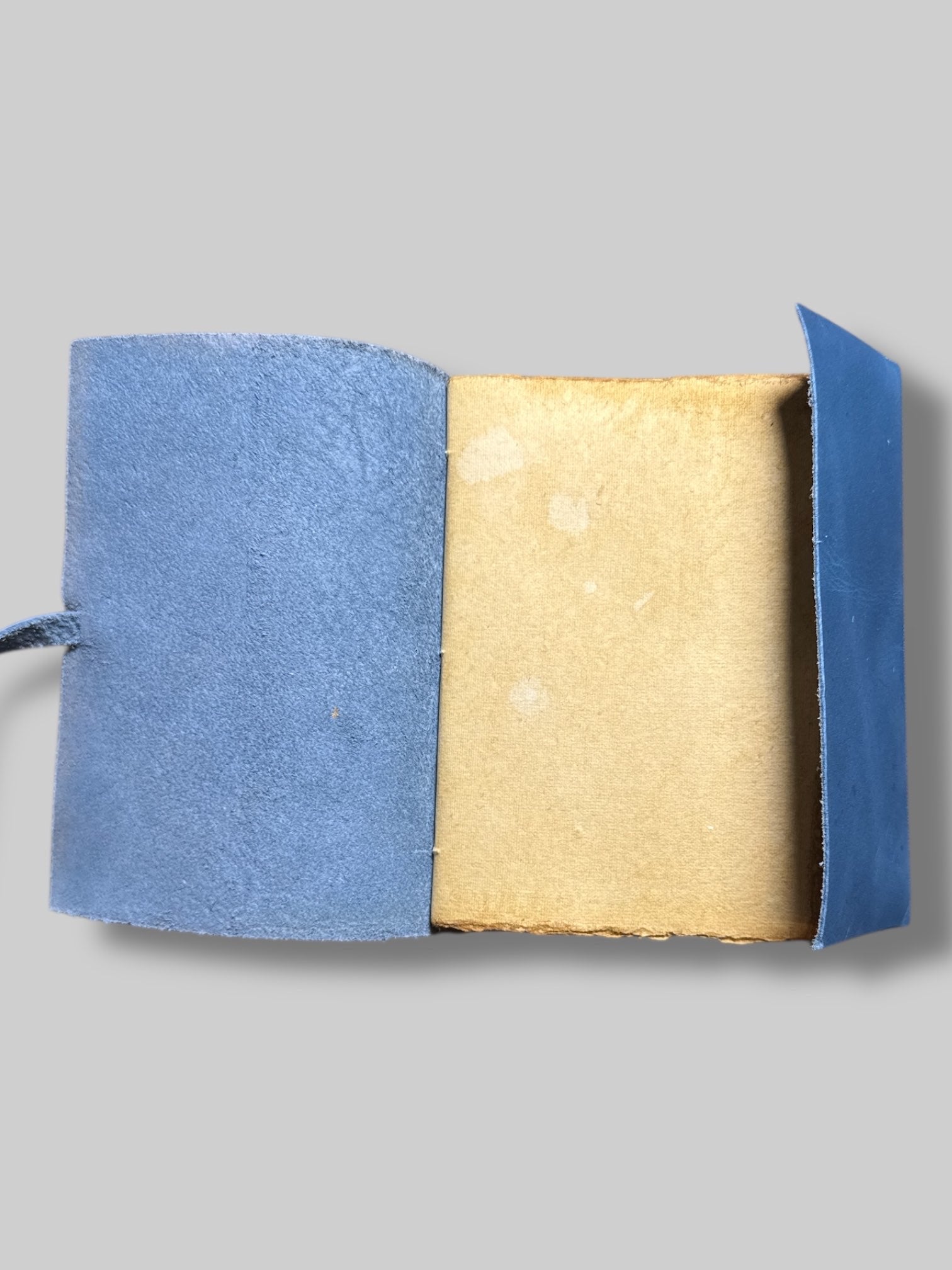 7” by 4.5”  blue leather bound tie journal with owl embossing