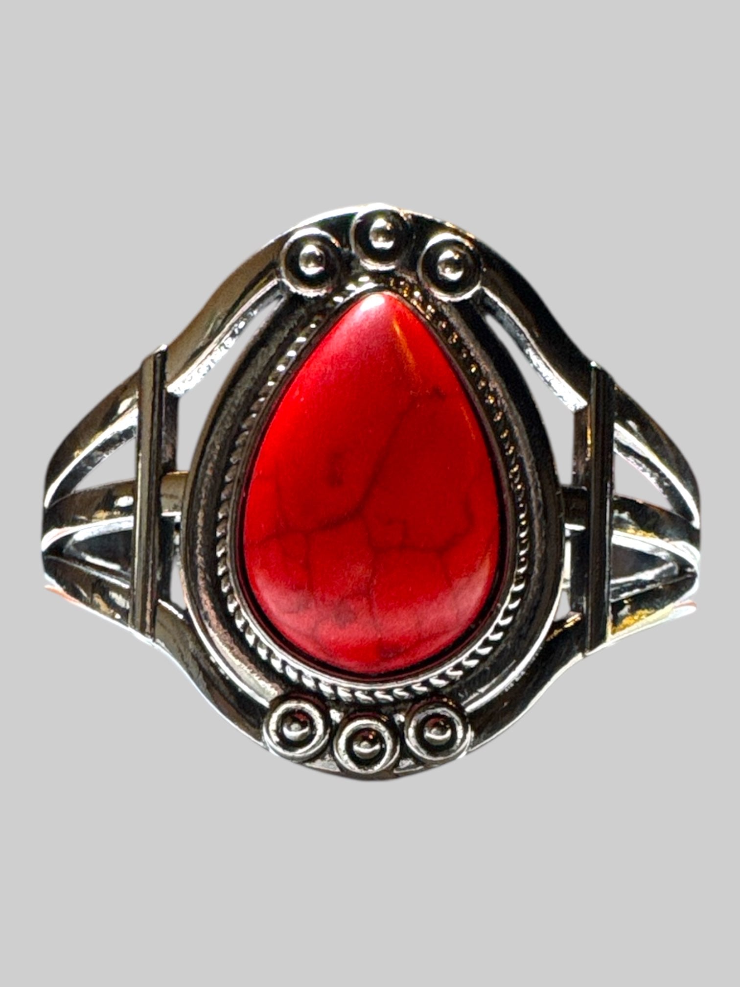 Silver tone cuff bracelet with red stone