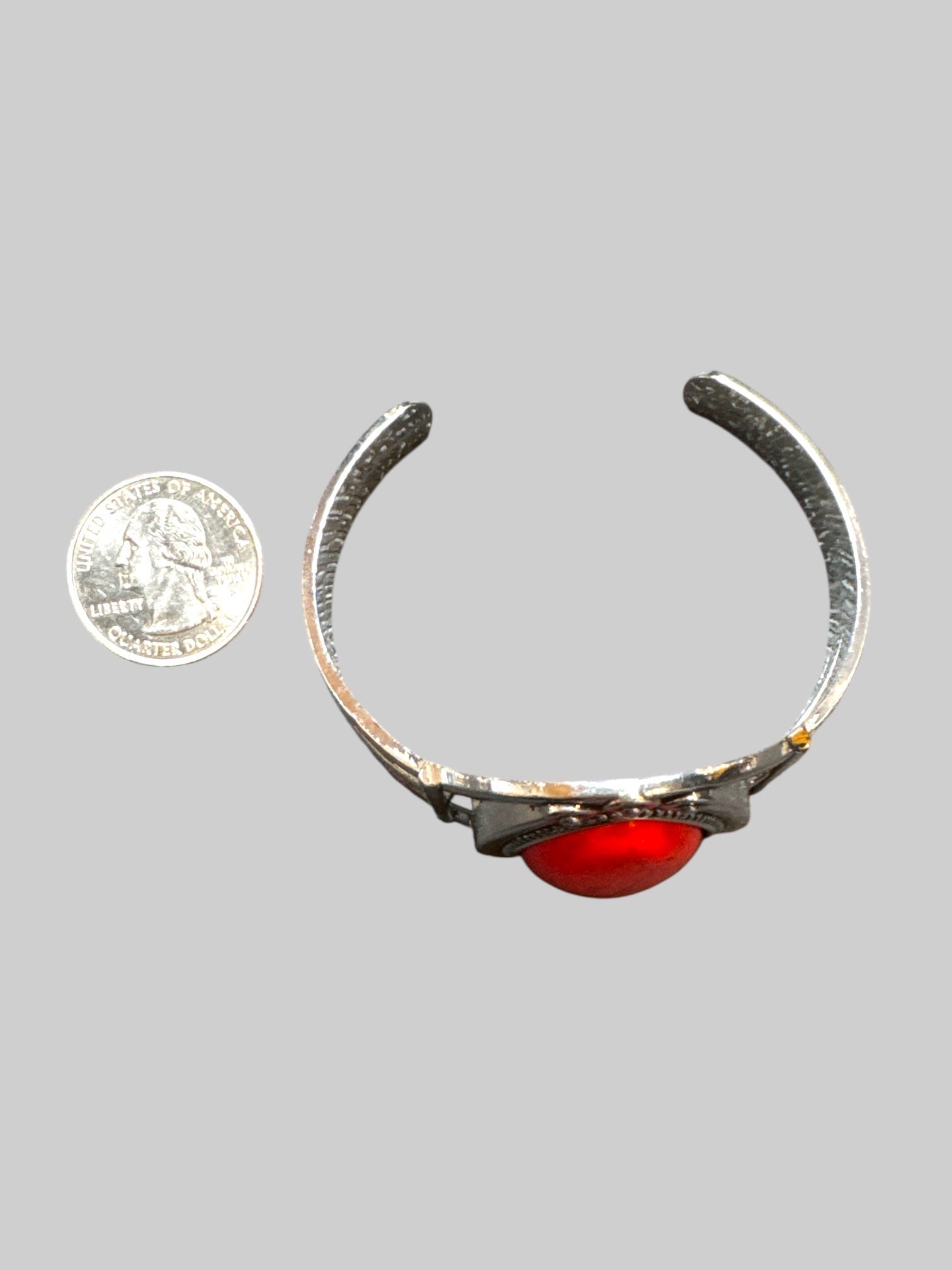 Silver tone cuff bracelet with red stone