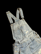 Load image into Gallery viewer, S Light blue distressed denim overall shorts w/ adjustable straps, pockets, belt loops, cuffed hems, &amp; side button closures
