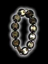 Load image into Gallery viewer, Gold-like bracelet w/ circular black, metallic copper, &amp; metallic green stones
