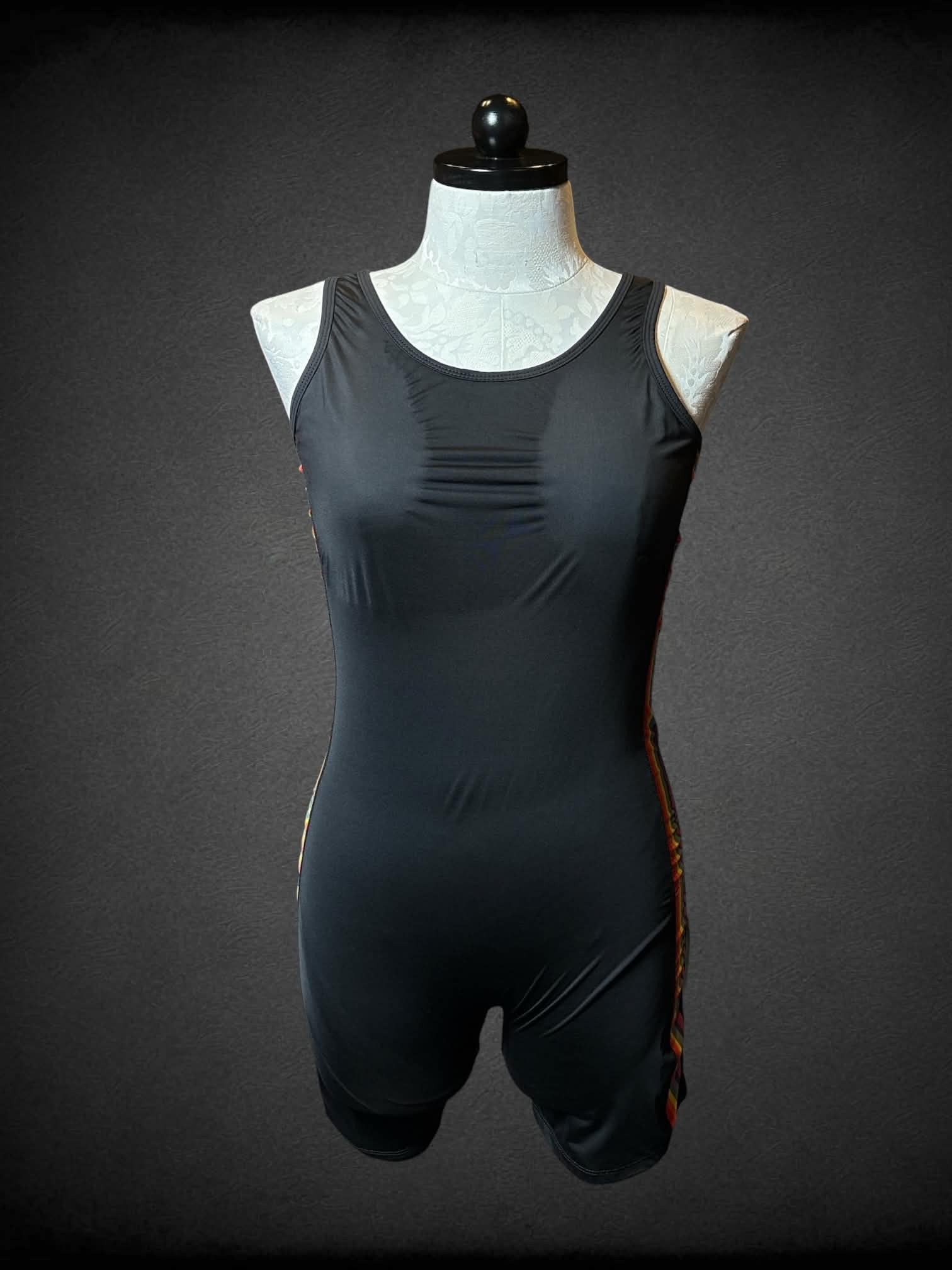 0X Tomboy X black body suit with rainbow lining on each side, and cutout on back