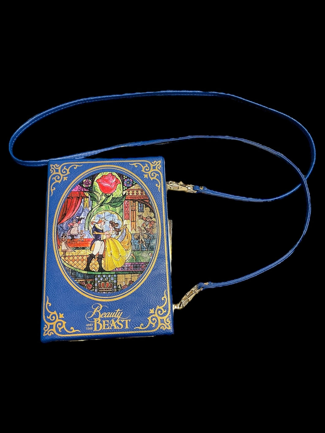 Dark blue “Beauty & The Beast” book shaped bag w/ detachable strap, gold-like accents, internal card wallet, internal pouch, & clasp closure