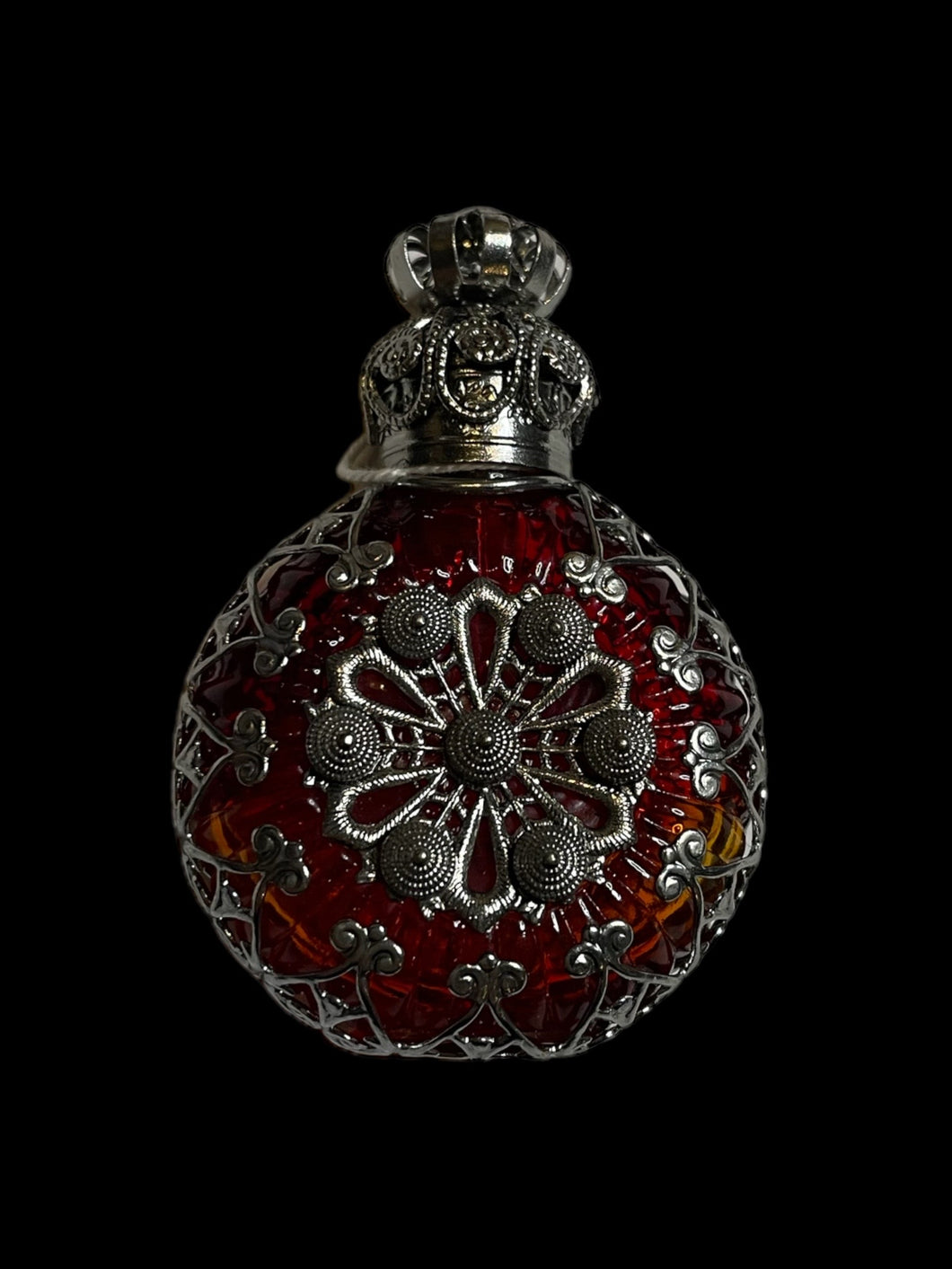 Silver-like & red ornate setting round perfume bottle