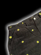 Load image into Gallery viewer, 1X Black corduroy high waist cutoff shorts w/ green &amp; yellow smiling floral embroidery, pockets, belt loops, &amp; button/zipper closure
