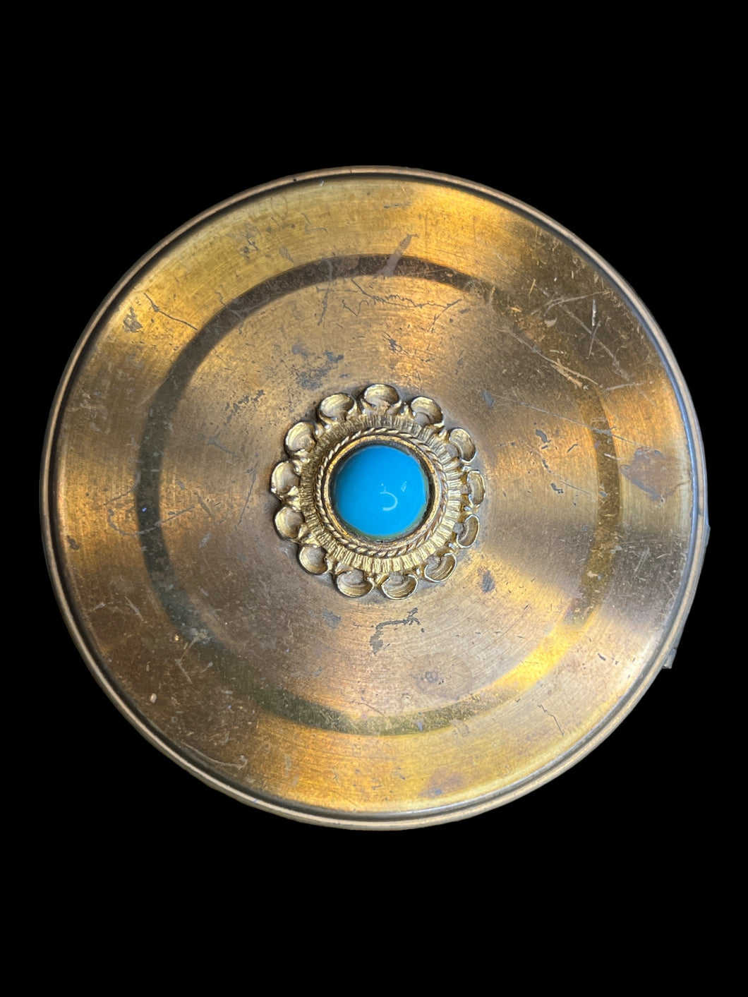 Brass-like circular box w/ light blue stone, hinge lid, & red velvet interior