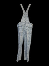 Load image into Gallery viewer, XL Light blue denim straight leg distressed overalls w/ splatter pattern, adjustable straps, pockets, &amp; two button side closure
