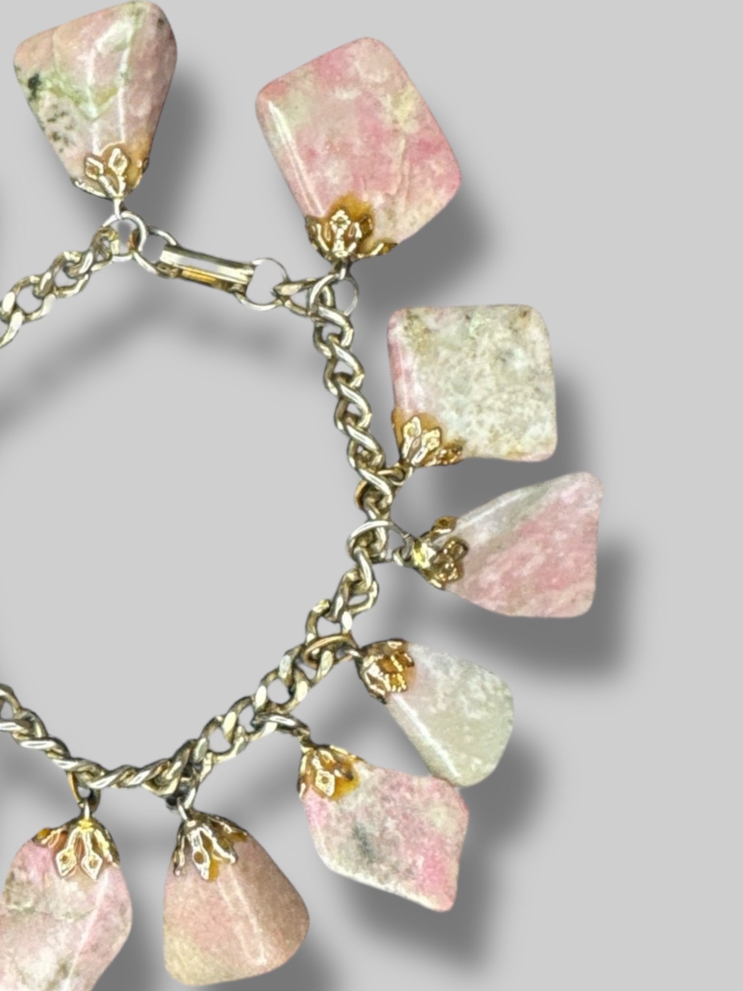 Chain charm bracelet with multiple pink and green gemstones and clasp closure