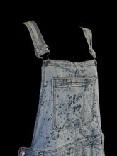 Load image into Gallery viewer, XL Light blue denim straight leg distressed overalls w/ splatter pattern, adjustable straps, pockets, &amp; two button side closure
