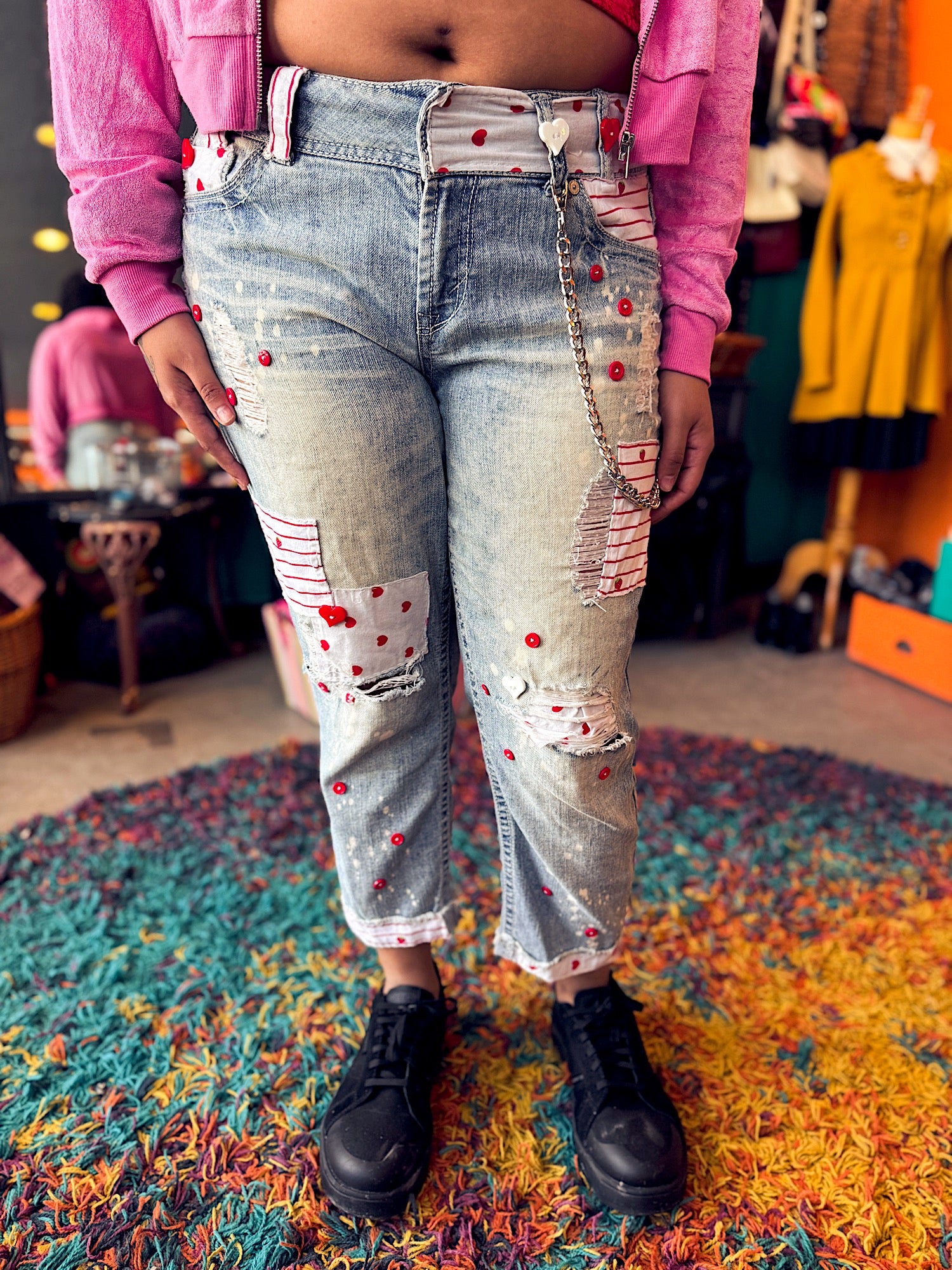 L WallFlower acid wash ripped jeans with silver wallet chain,  white and red buttons, strawberry/heart/striped fabric patches throughout