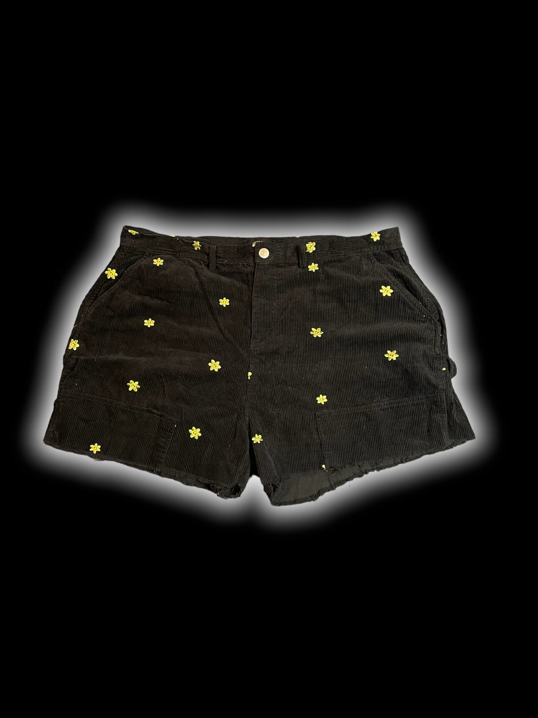1X Black corduroy high waist cutoff shorts w/ green & yellow smiling floral embroidery, pockets, belt loops, & button/zipper closure