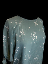 Load image into Gallery viewer, L Teal, white, &amp; black leaf pattern 1/2 balloon sleeve round neckline top w/ zipper closure
