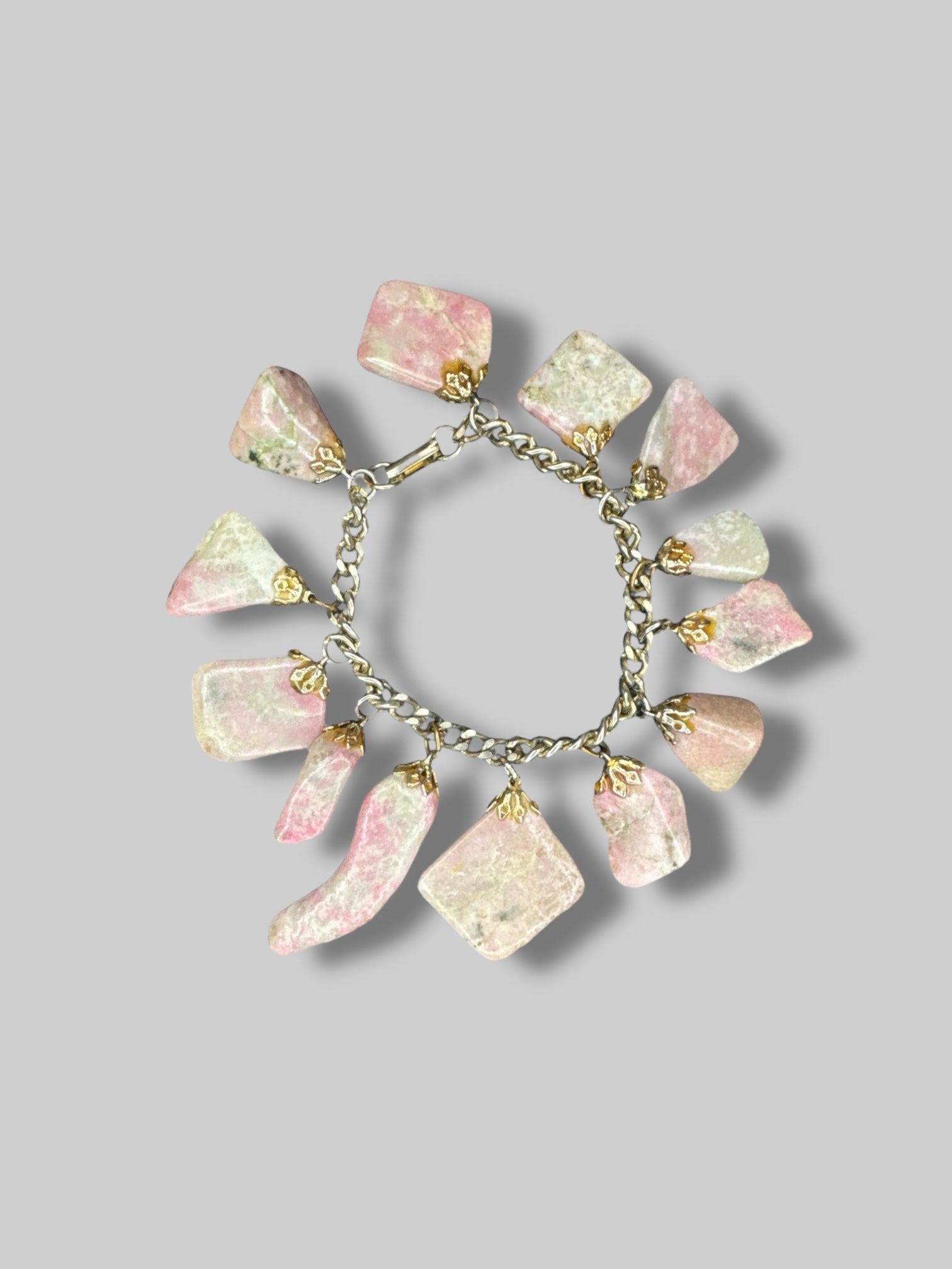 Chain charm bracelet with multiple pink and green gemstones and clasp closure