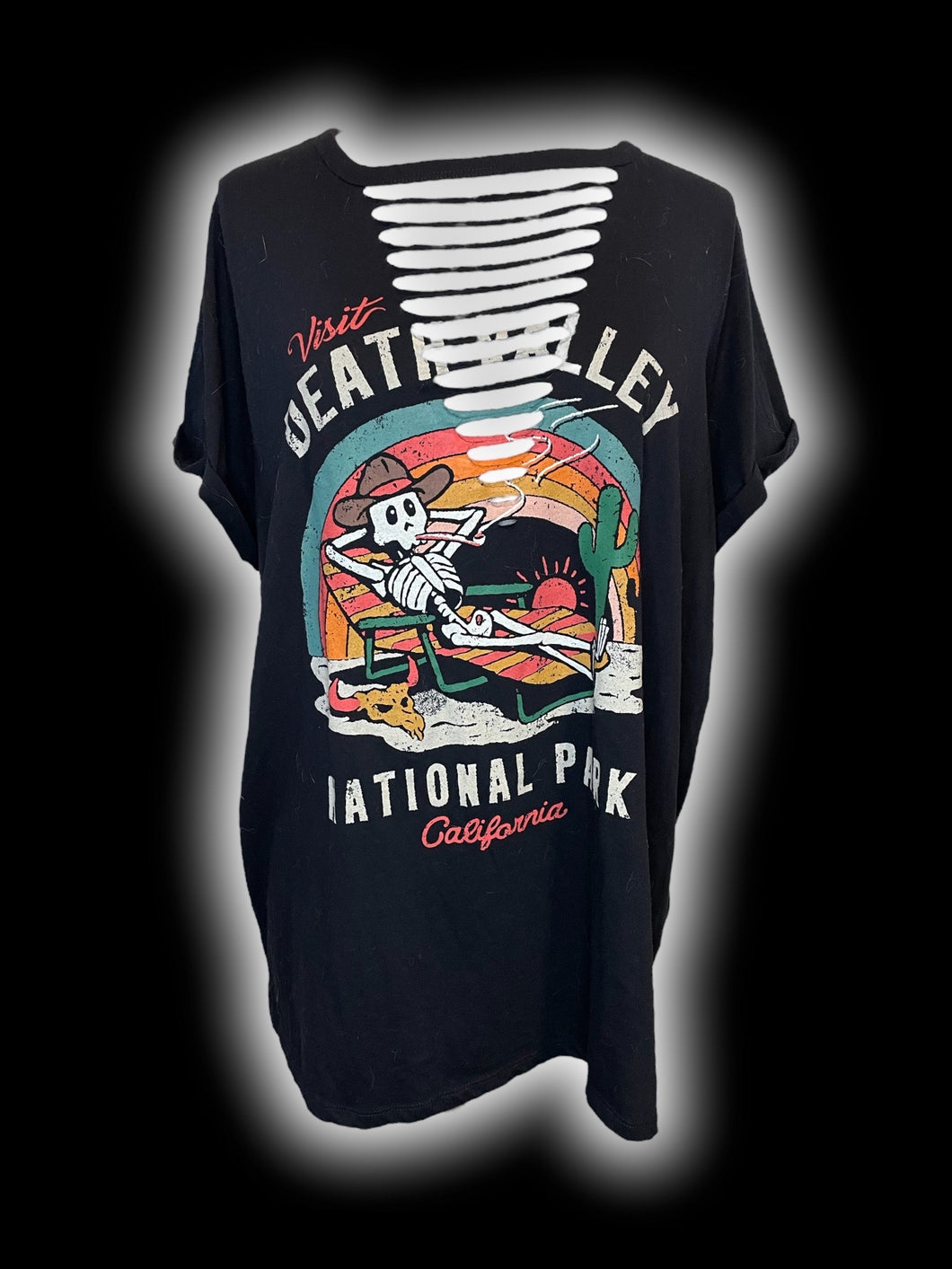 2X Black short sleeve scoop neck top w/ “Visit Death Valley National Park California” skeleton on a law chair graphic, distressed front, & folded cuffs